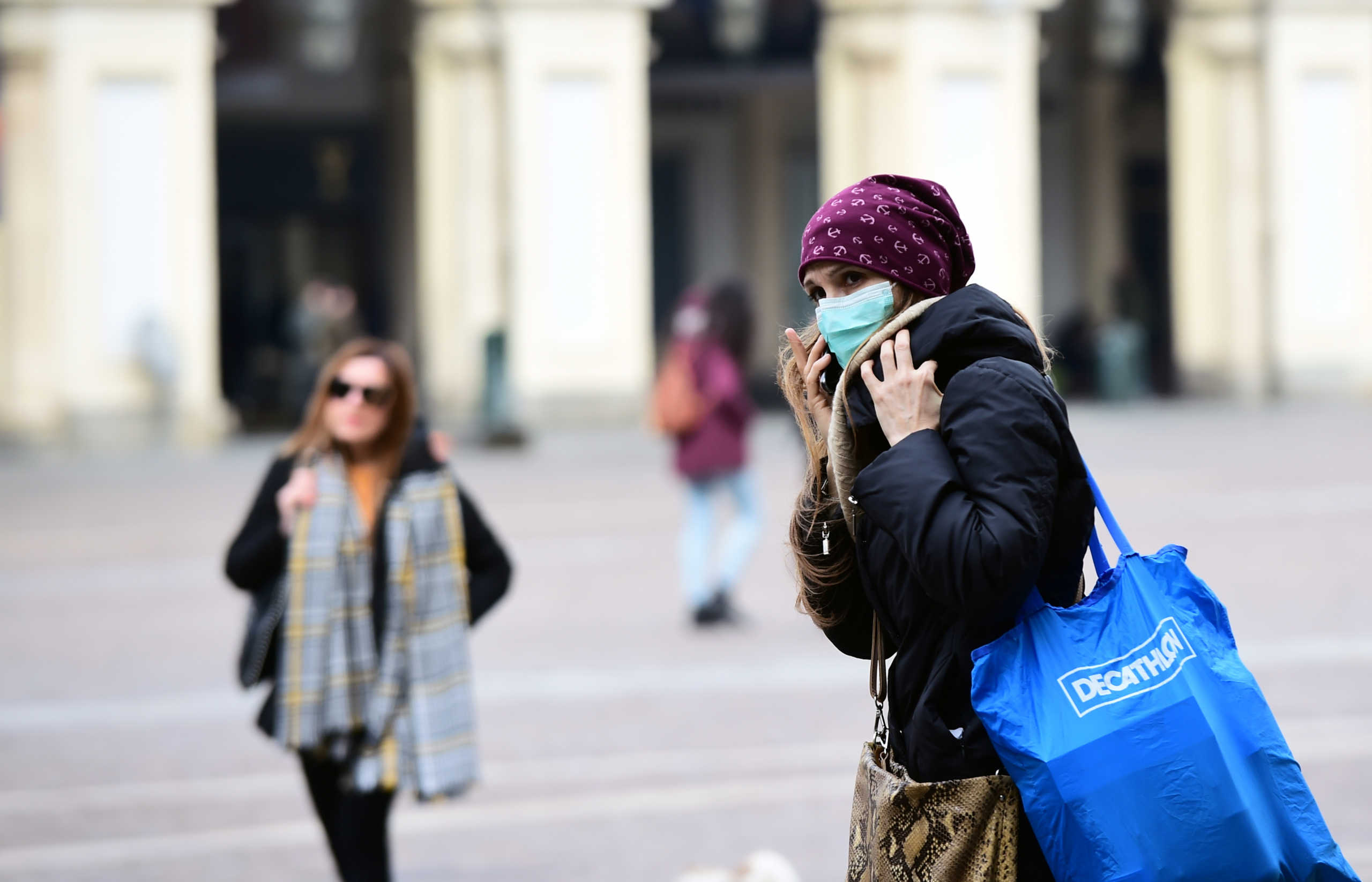 A woman wearing a protective face mask walks in the streets after the government decree to close cinemas, schools and urge people to work from home and not stand closer than one metre to each other, in Turin, Italy March 5, 2020. REUTERS
