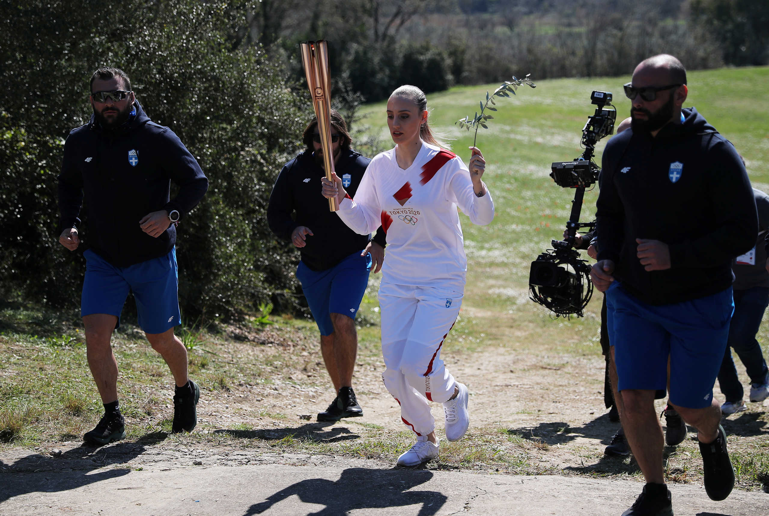 Olympics - Lighting ceremony of the Olympic flame for Tokyo 2020 - Ancient Olympia, Olympia, Greece - March 12, 2020   First torchbearer, Greek shooting athlete Anna Korakaki, carries the torch during the opening of the Olympic flame torch relay for the Tokyo 2020 Summer Olympics    REUTERS