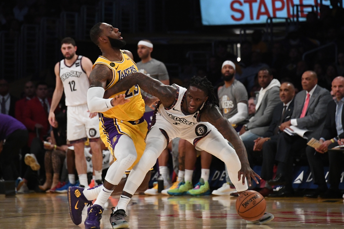 Mar 10, 2020; Los Angeles, California, USA; Brooklyn Nets guard Theo Pinson (1) and Los Angeles Lakers forward LeBron James (23) battle for the ball in the second half at Staples Center. Mandatory Credit: Richard Mackson-USA TODAY Sports