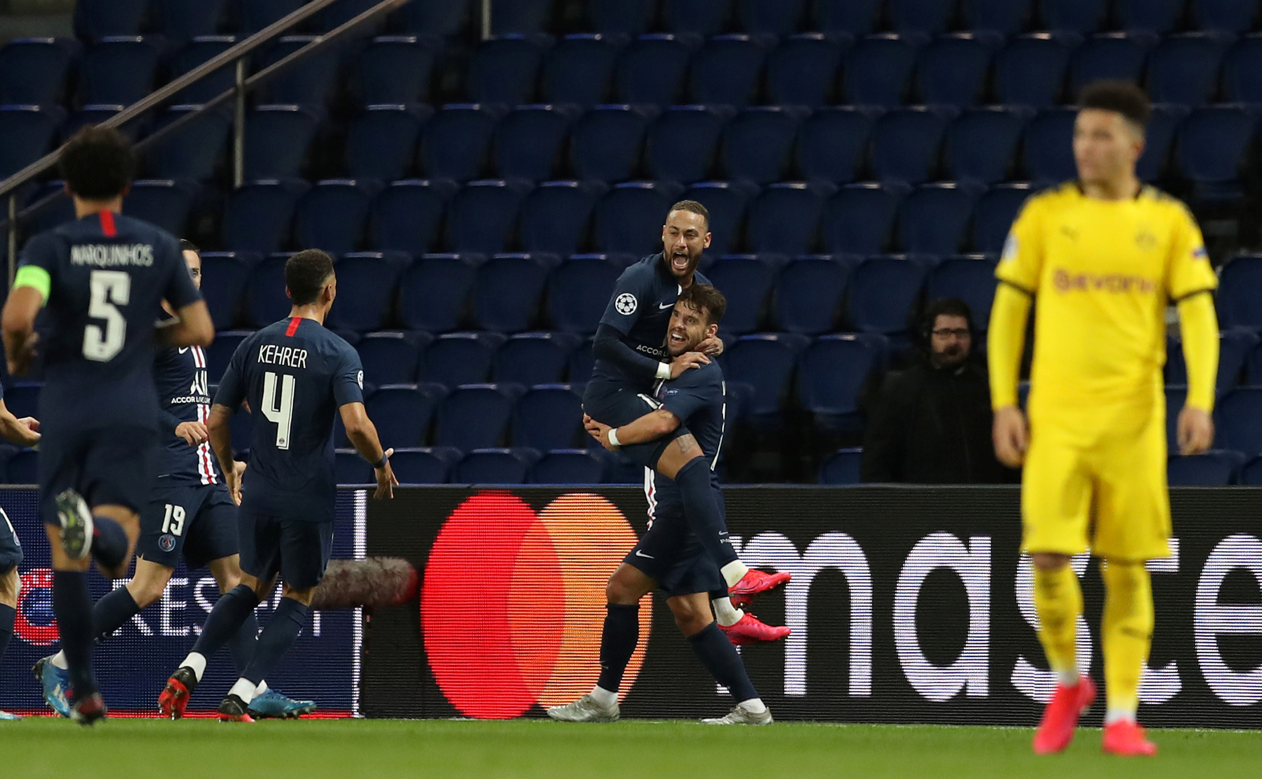 Soccer Football - Champions League - Round of 16 Second Leg - Paris St Germain v Borussia Dortmund - Parc des Princes, Paris, France - March 11, 2020  Paris St Germain's Juan Bernat celebrates scoring their second goal with Neymar and teammates   UEFA Pool