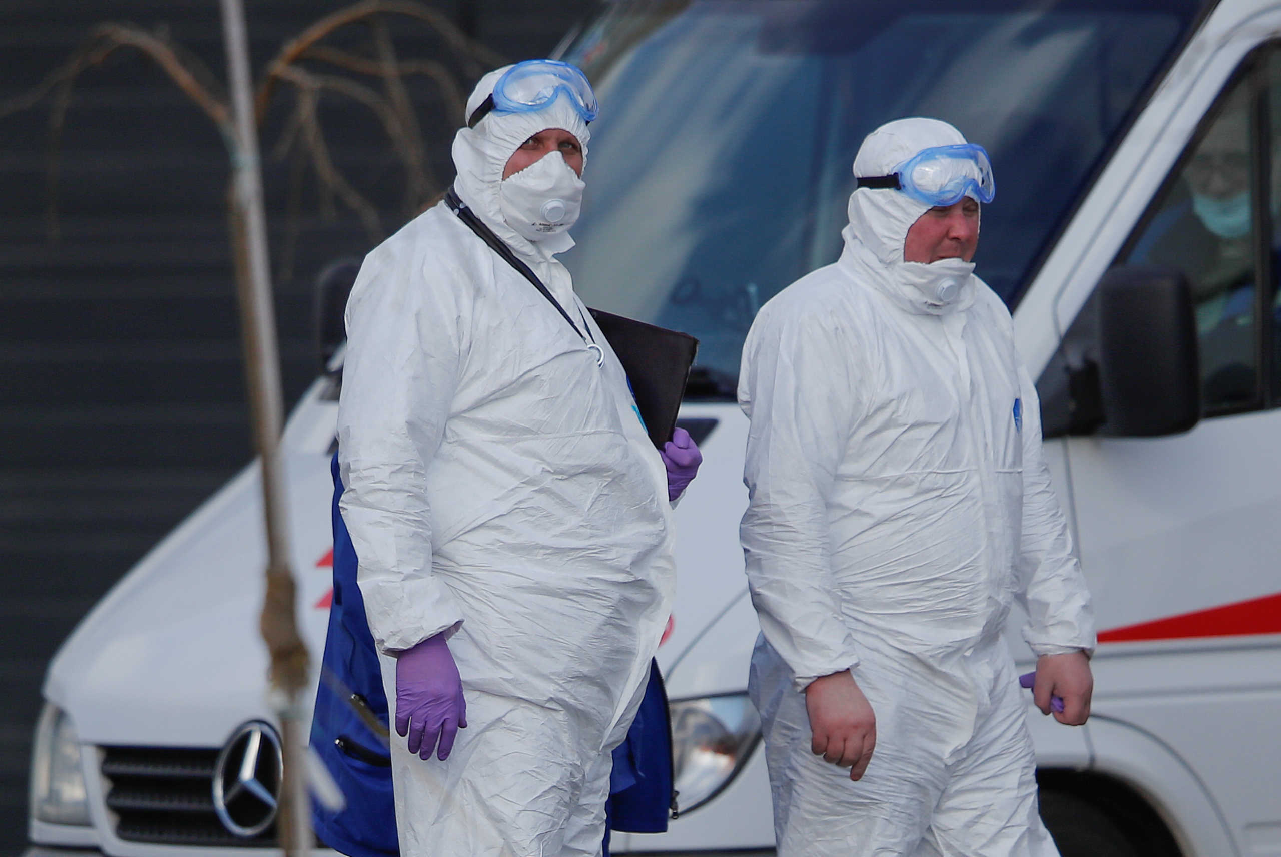 Medical specialists wearing protective gear gather outside a hospital for patients infected with coronavirus disease (COVID-19) on the outskirts of Moscow, Russia March 23, 2020. REUTERS
