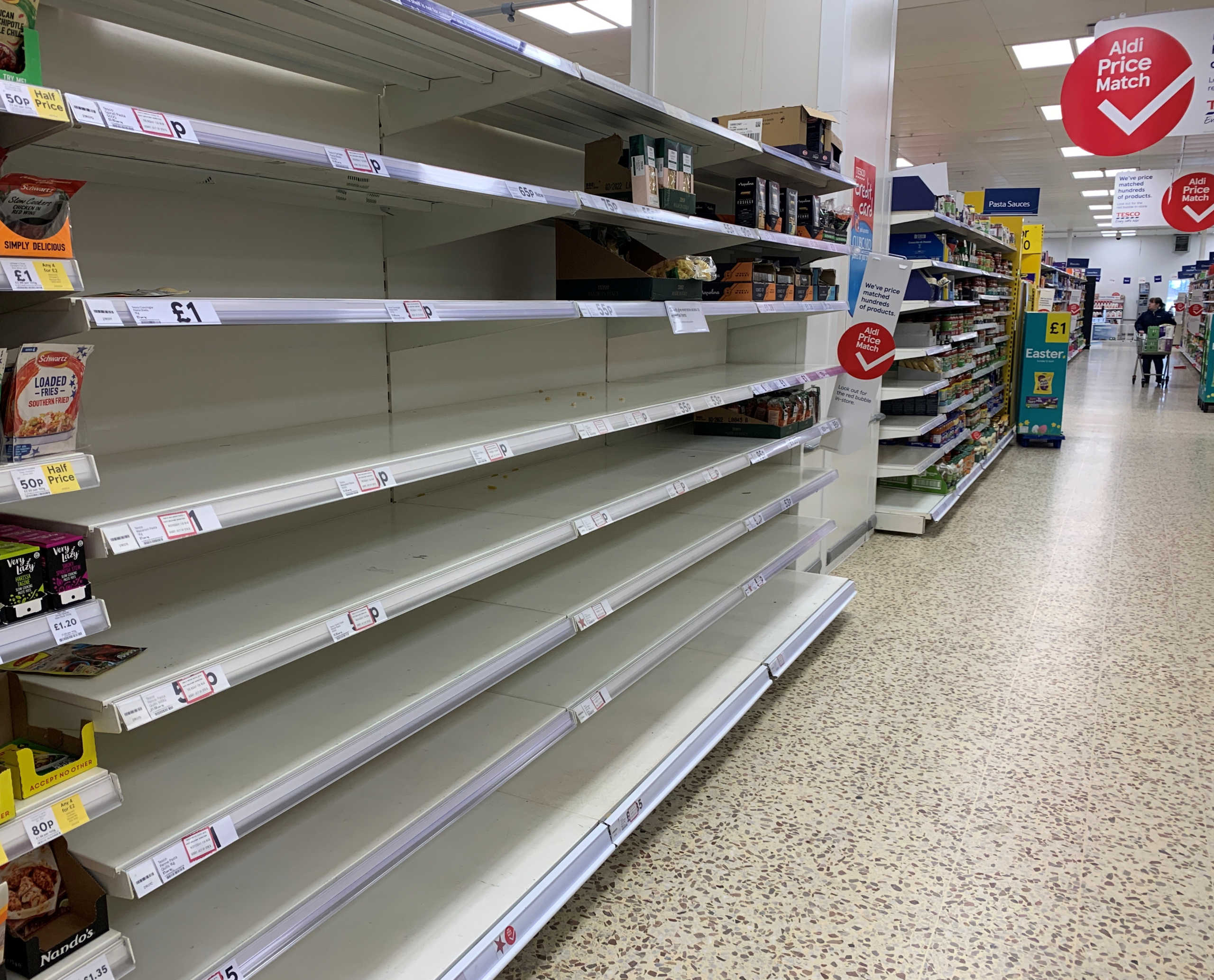Empty shelves are seen in the pasta aisle inside a Tesco supermarket in Manchester, Britain, March 9, 2020. REUTERS