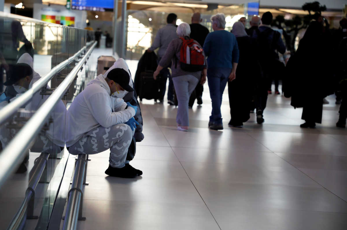 A man wears a protective face mask in light of the coronavirus, at Istanbul Airport, Turkey, March 13, 2020. REUTERS