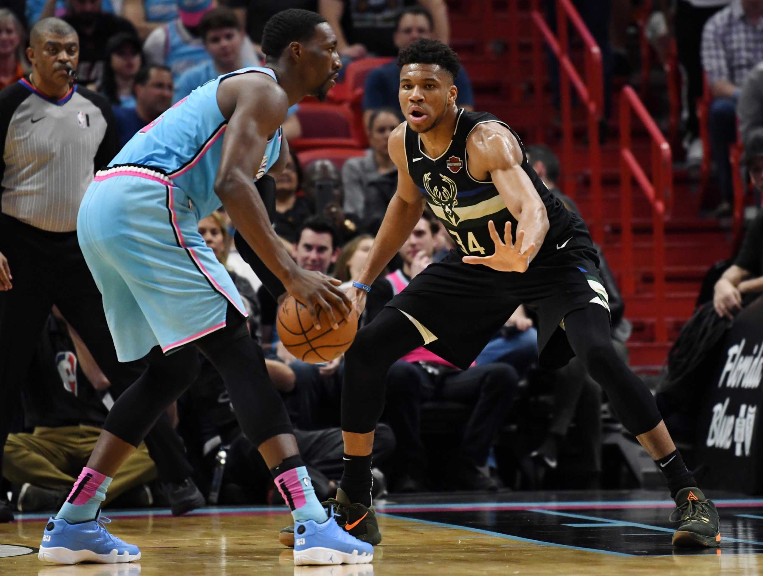 Mar 2, 2020; Miami, Florida, USA; Milwaukee Bucks forward Giannis Antetokounmpo (34) defends Miami Heat forward Bam Adebayo (13) in the second quarter at American Airlines Arena. Mandatory Credit: Jim Rassol-USA TODAY Sports