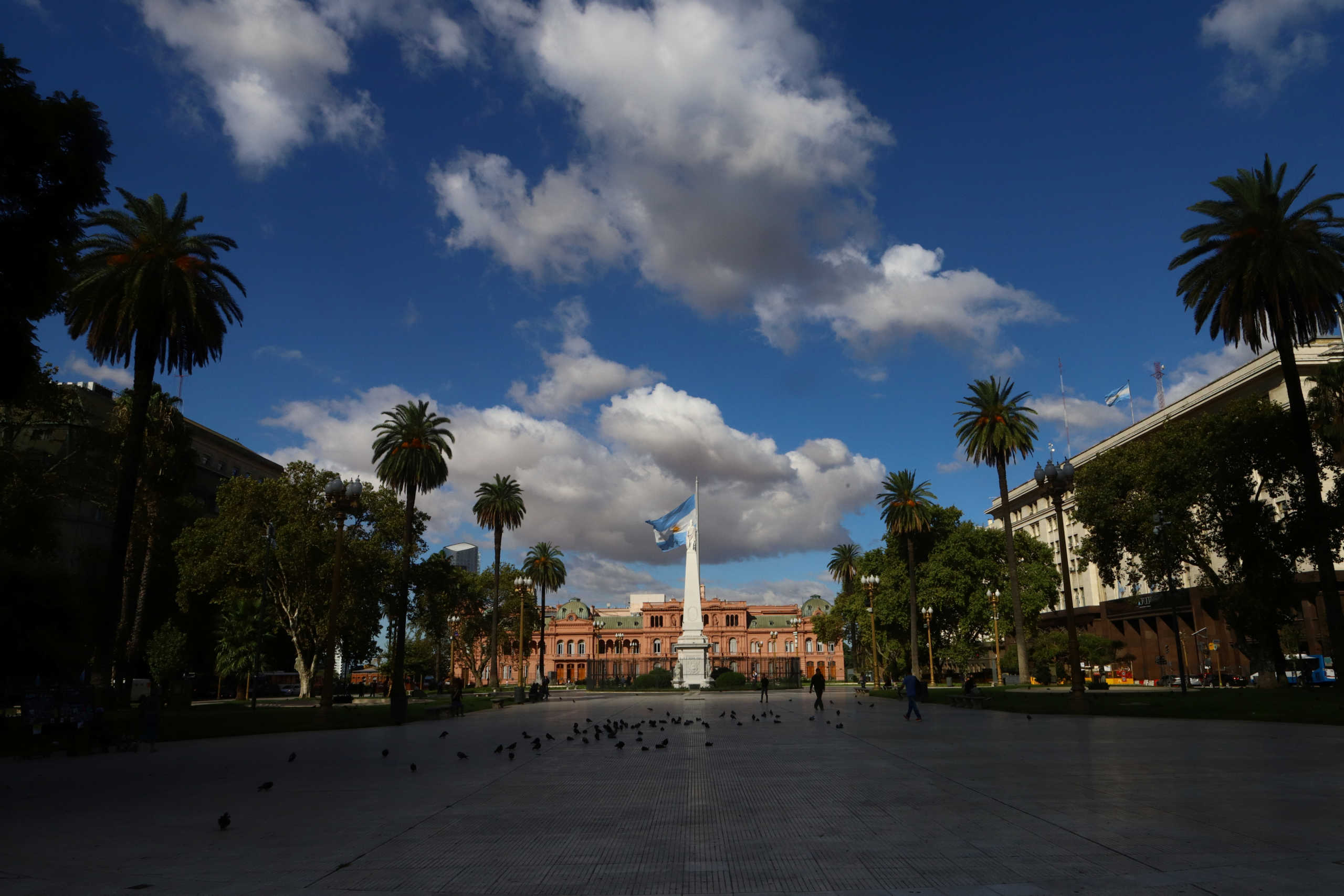 People walk around the historic Plaza de Mayo during a sunny afternoon of clear skies as the spread of coronavirus disease (COVID-19) continues in Buenos Aires, Argentina March 19, 2020. Reuters