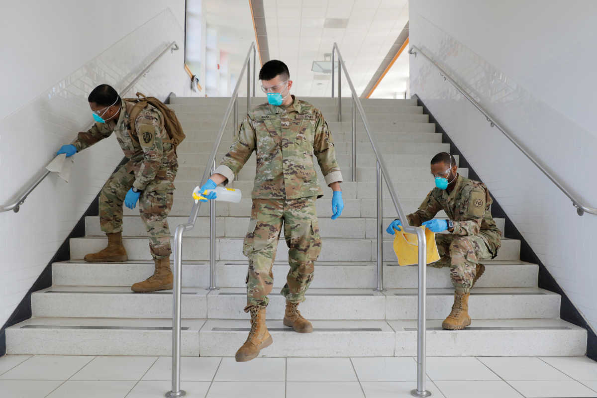 Members of Joint Task Force 2, composed of soldiers and airmen from the New York Army and Air National Guard, work to sanitize the New Rochelle High School during the coronavirus disease (COVID-19) outbreak in New Rochelle, New York, U.S., March 21, 2020. REUTERS