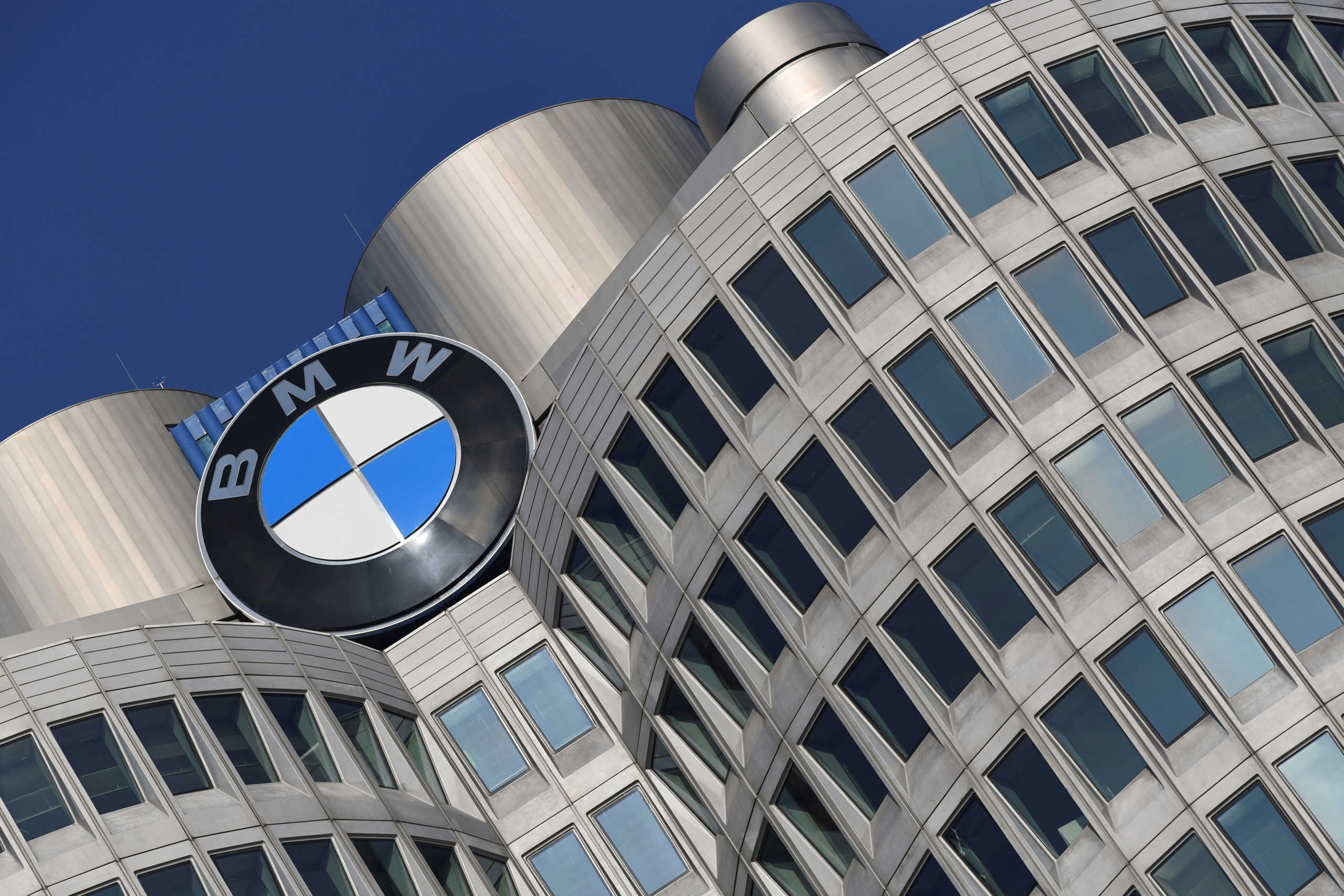 FILE PHOTO: The logo of German car manufacturer BMW is seen on the company headquarters in Munich, Germany, December 5, 2019. REUTERS