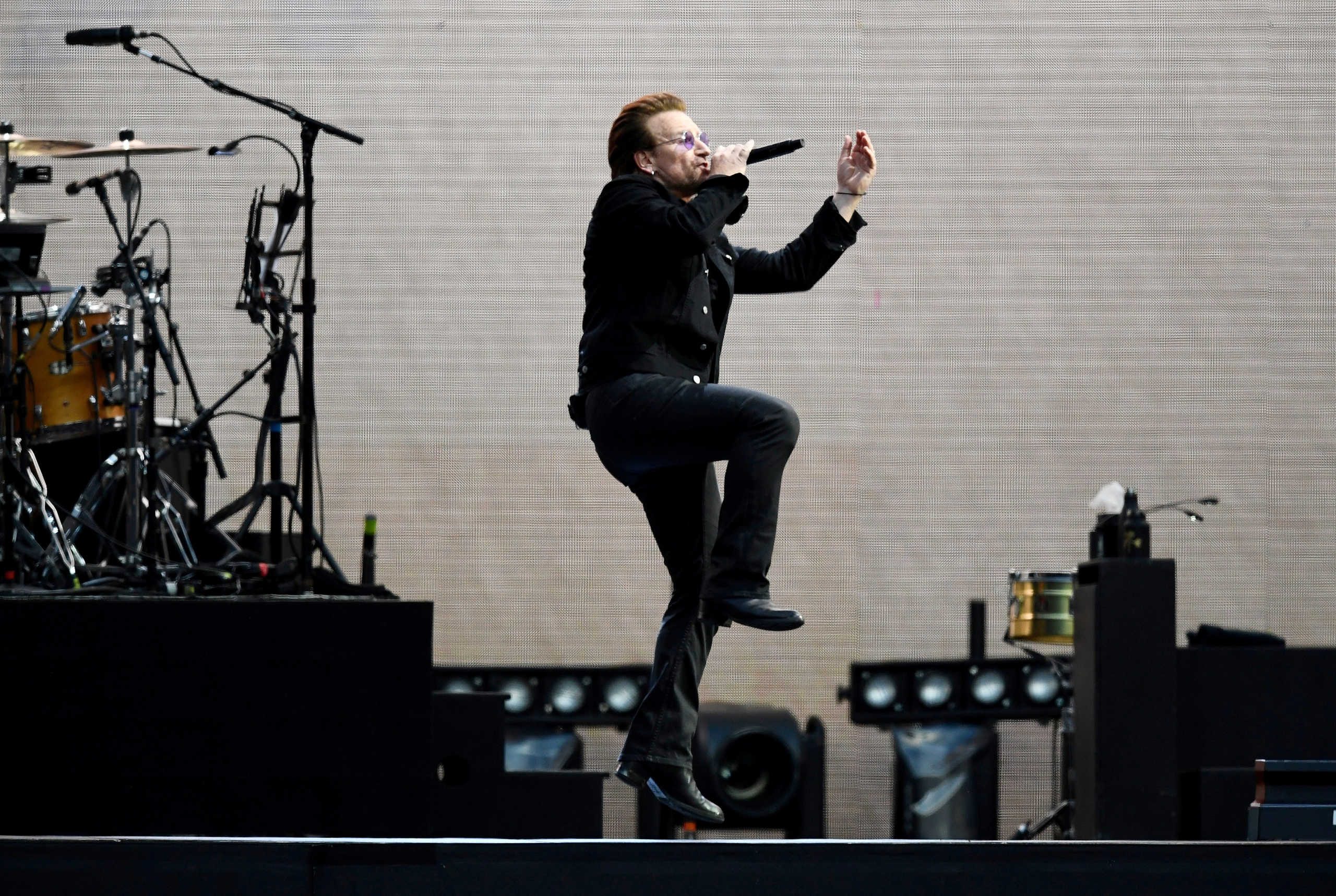 FILE PHOTO: Bono sings as U2 perform during their U2: The Joshua Tree Tour, at Twickenham Stadium, London, Britain, July 8, 2017. REUTERS