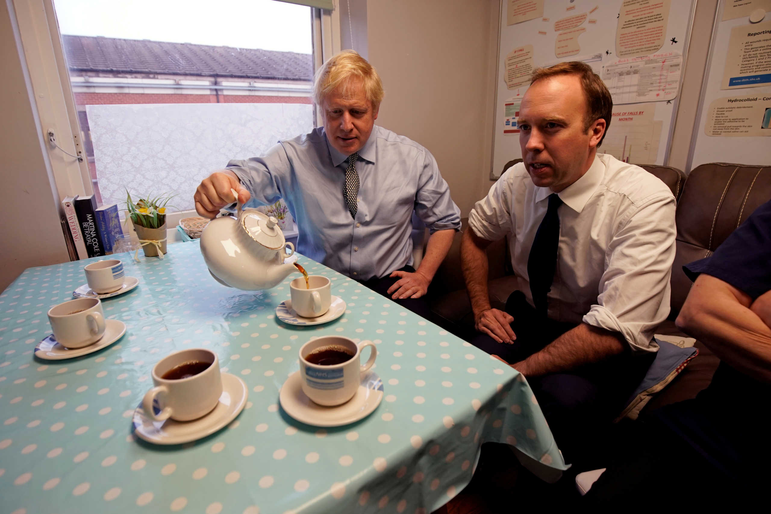 FILE PHOTO: Britain's Prime Minister Boris Johnson and Health Secretary Matt Hancock have tea with members of staff as they visit Bassetlaw District General Hospital in Worksop, Britain November 22, 2019. Picture taken November 22, 2019. Christopher Furlong