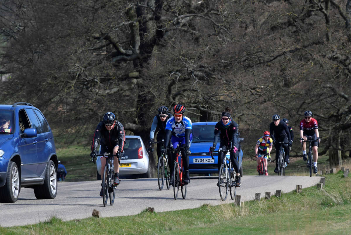 Cyclists and vehicles are seen in Richmond Park with the City of London skyline behind, as the number of coronavirus disease cases (COVID-19) grow around the world,  London, Britain, March 21, 2020. Picture taken on March 21. REUTERS