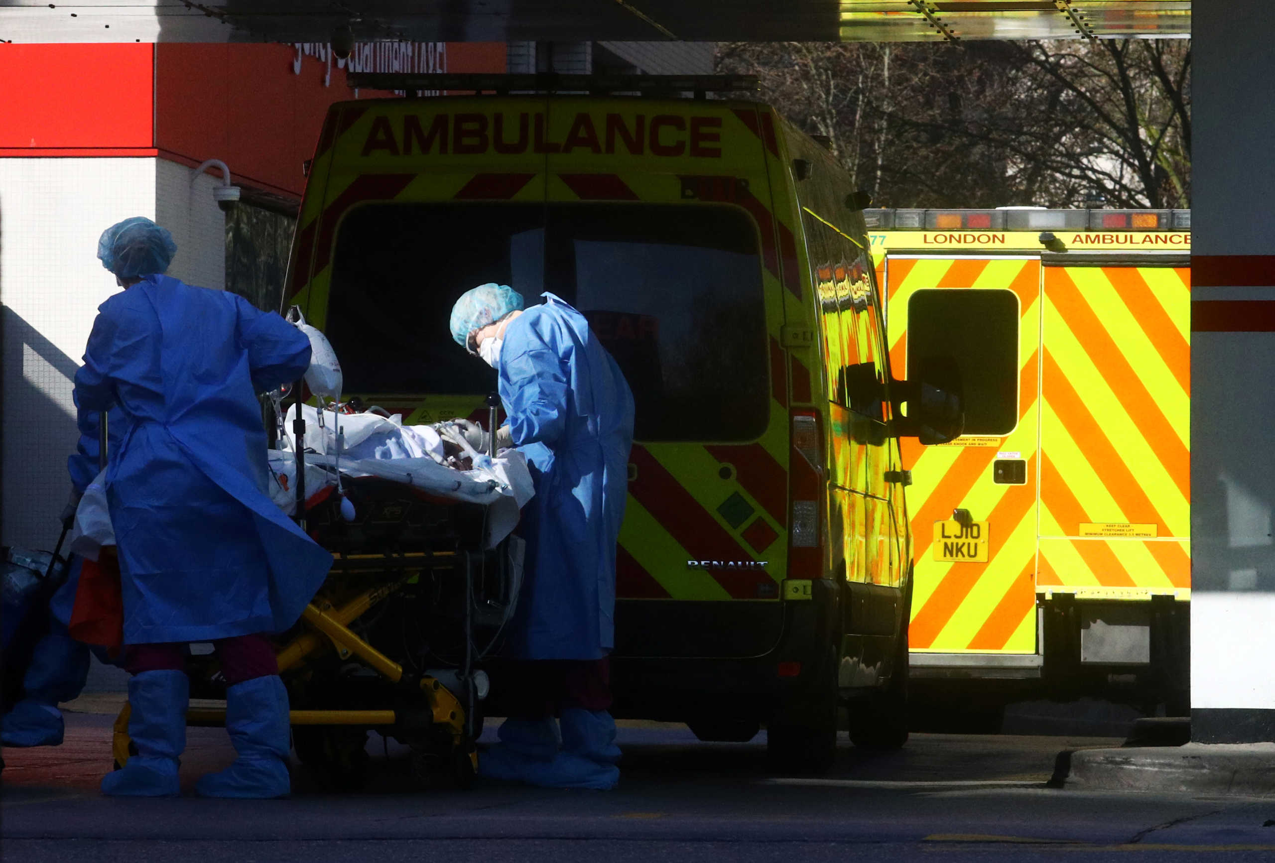 Medical staff with a patient at the back of ambulance outside St Thomas' hospital as the spread of the coronavirus disease (COVID-19) in London, Britain, March 26, 2020. REUTERS