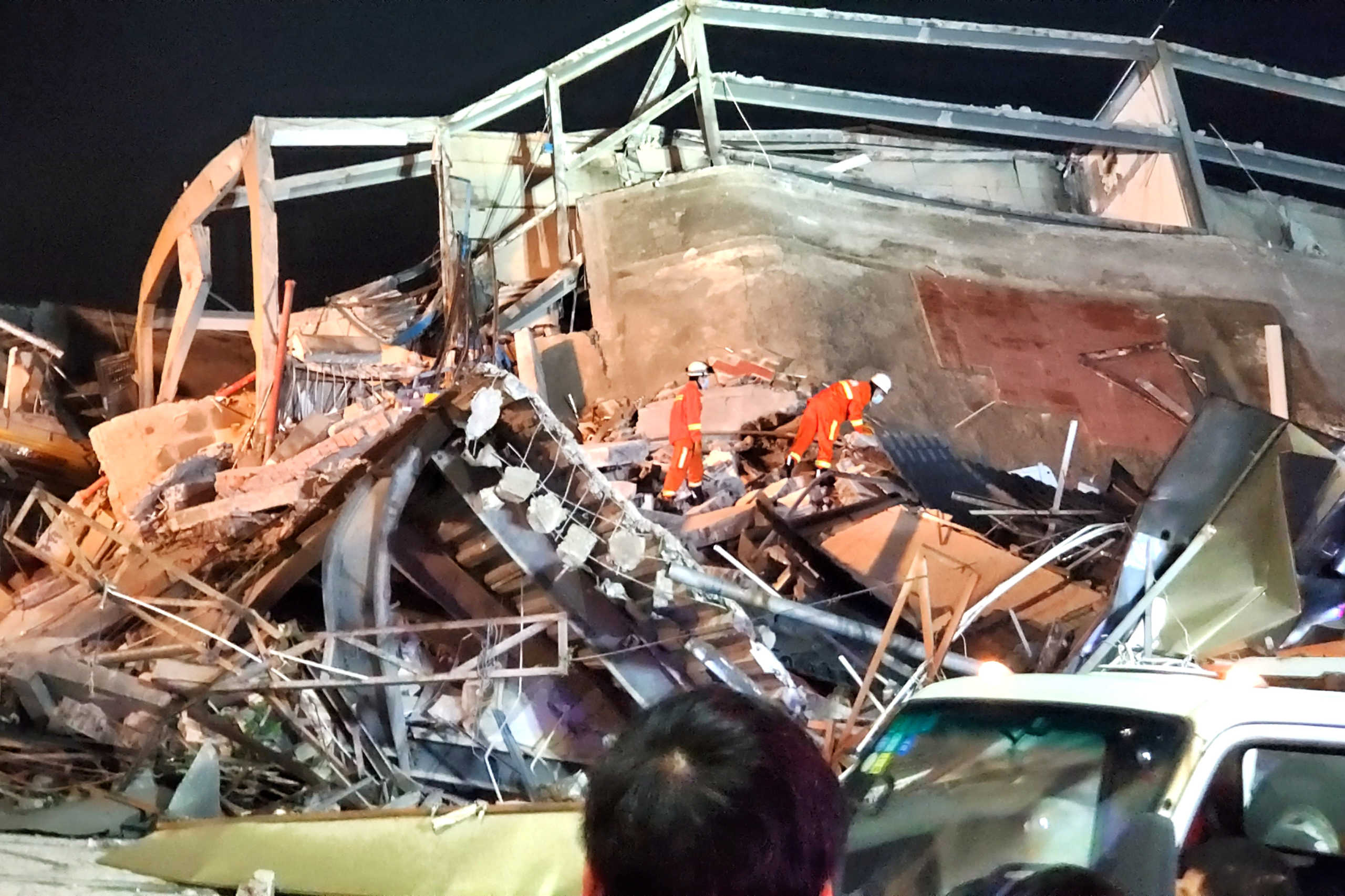 Rescue workers are seen on the site where a hotel being used for the novel coronavirus quarantine collapsed in the southeast Chinese port city of Quanzhou, Fujian province, China March 7, 2020. Picture taken March 7, 2020. cnsphoto via REUTERS. ATTENTION EDITORS - THIS IMAGE WAS PROVIDED BY A THIRD PARTY. CHINA OUT.