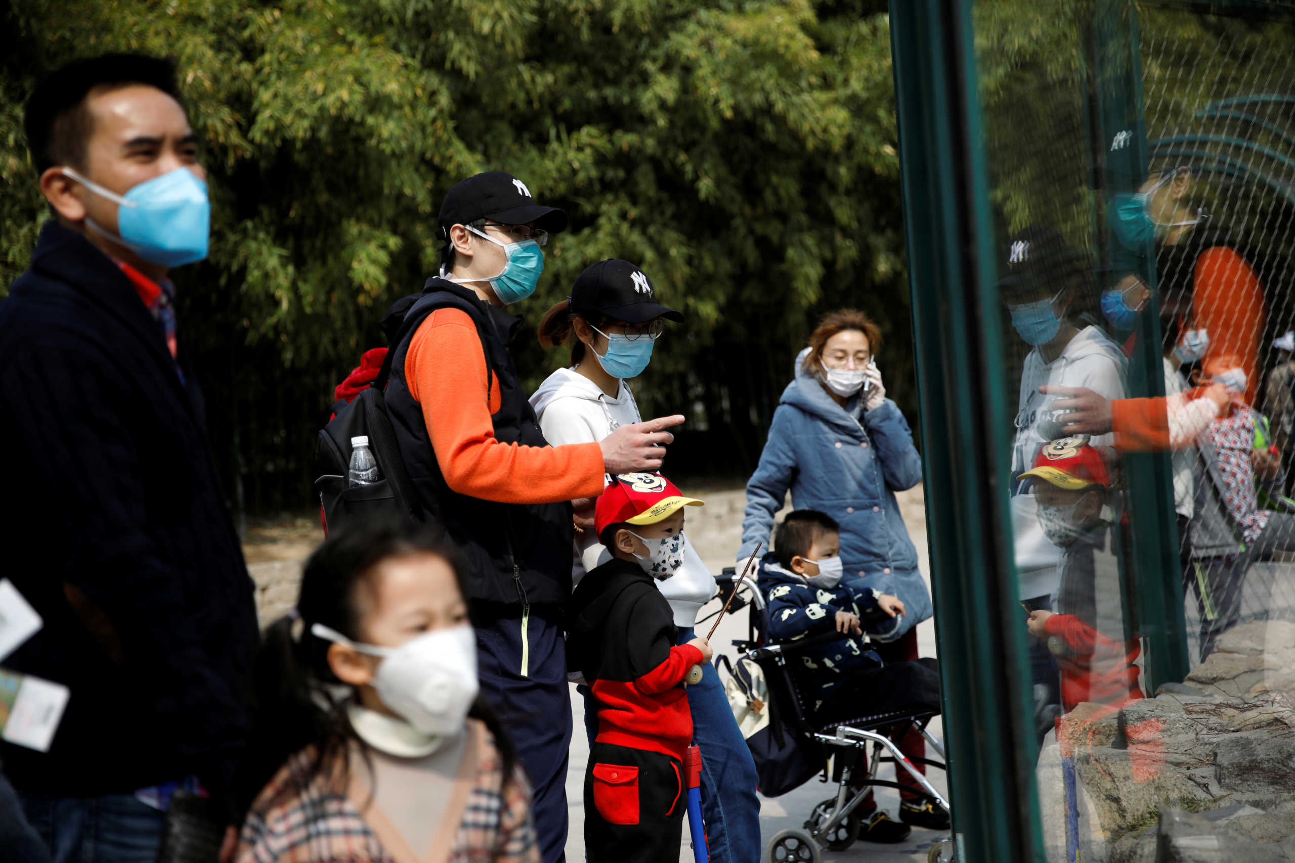 People wearing face masks visit Beijing Zoo, which has partially reopened after closing in late January due to the coronavirus disease (COVID-19) outbreak, in China, March 24, 2020. REUTERS