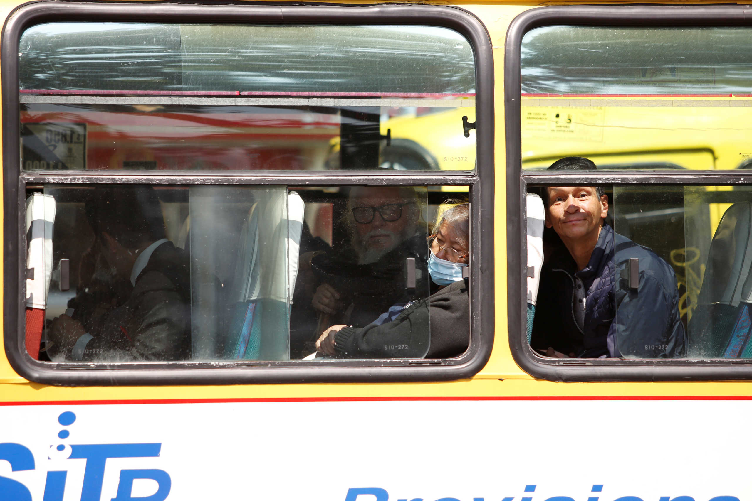 A woman wearing a protective mask inside a bus, as a preventive measure against the spread of the coronavirus disease (COVID-19), in Bogota, Colombia March 17, 2020. REUTERS