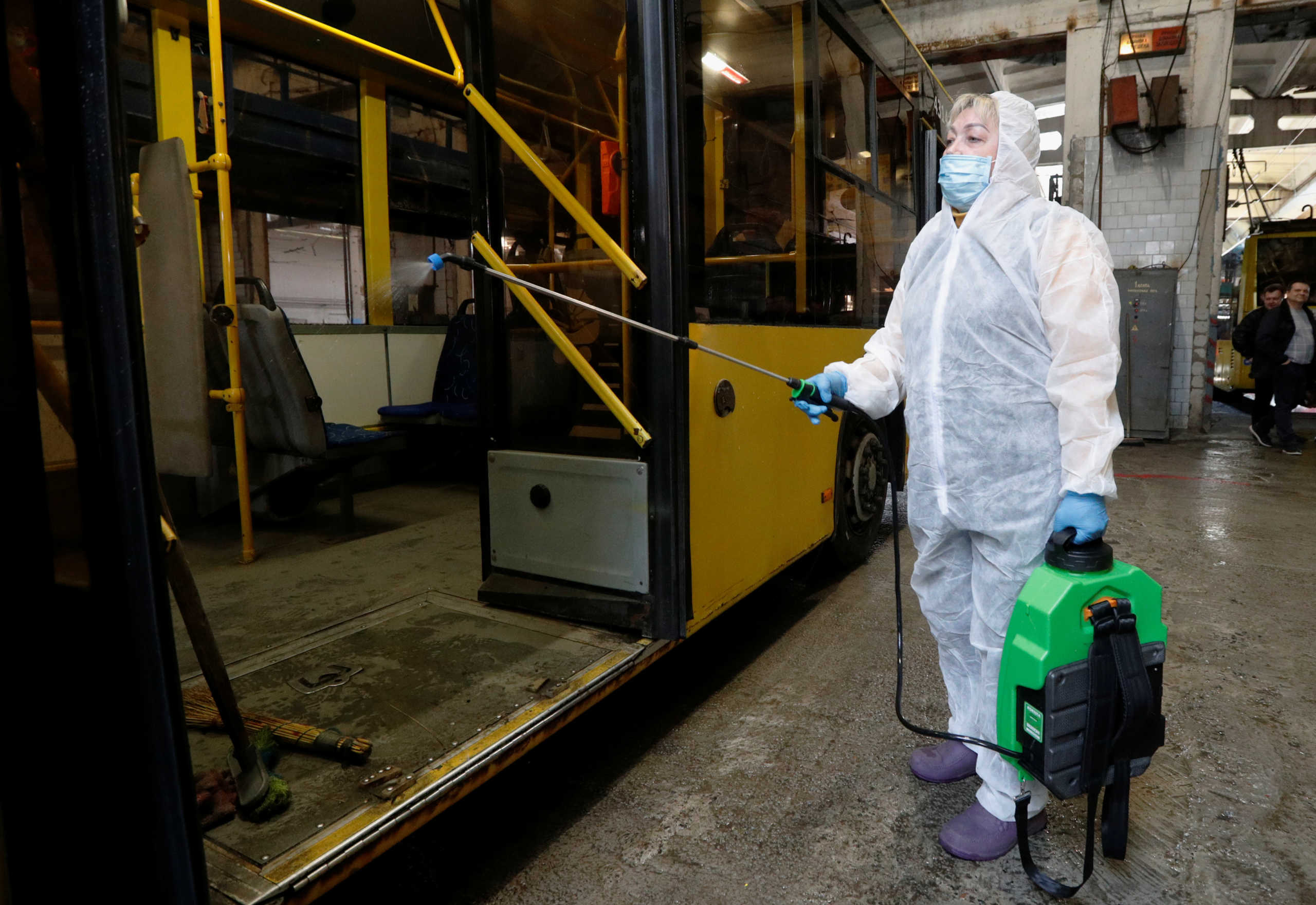 A worker wearing a protective suit disinfects a trolley bus due to coronavirus (COVID-19) concerns in Kiev, Ukraine March 12, 2020. REUTERS