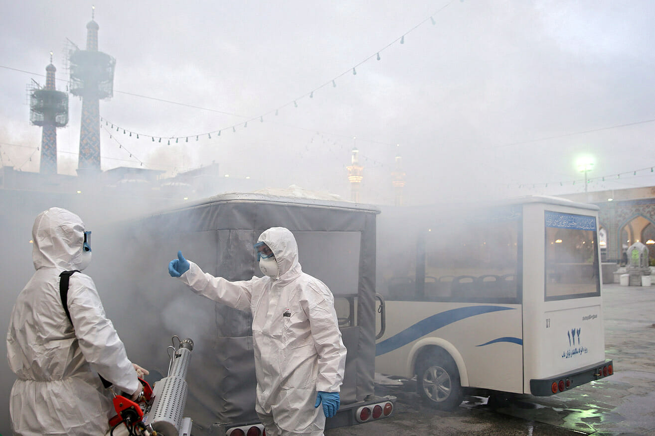 Members of the medical team spray disinfectant to sanitize outdoor place of Imam Reza's holy shrine, following the coronavirus outbreak, in Mashhad, Iran February 27, 2020. Picture taken February 27, 2020. WANA (West Asia News Agency) via REUTERS ATTENTION EDITORS - THIS PICTURE WAS PROVIDED BY A THIRD PARTY