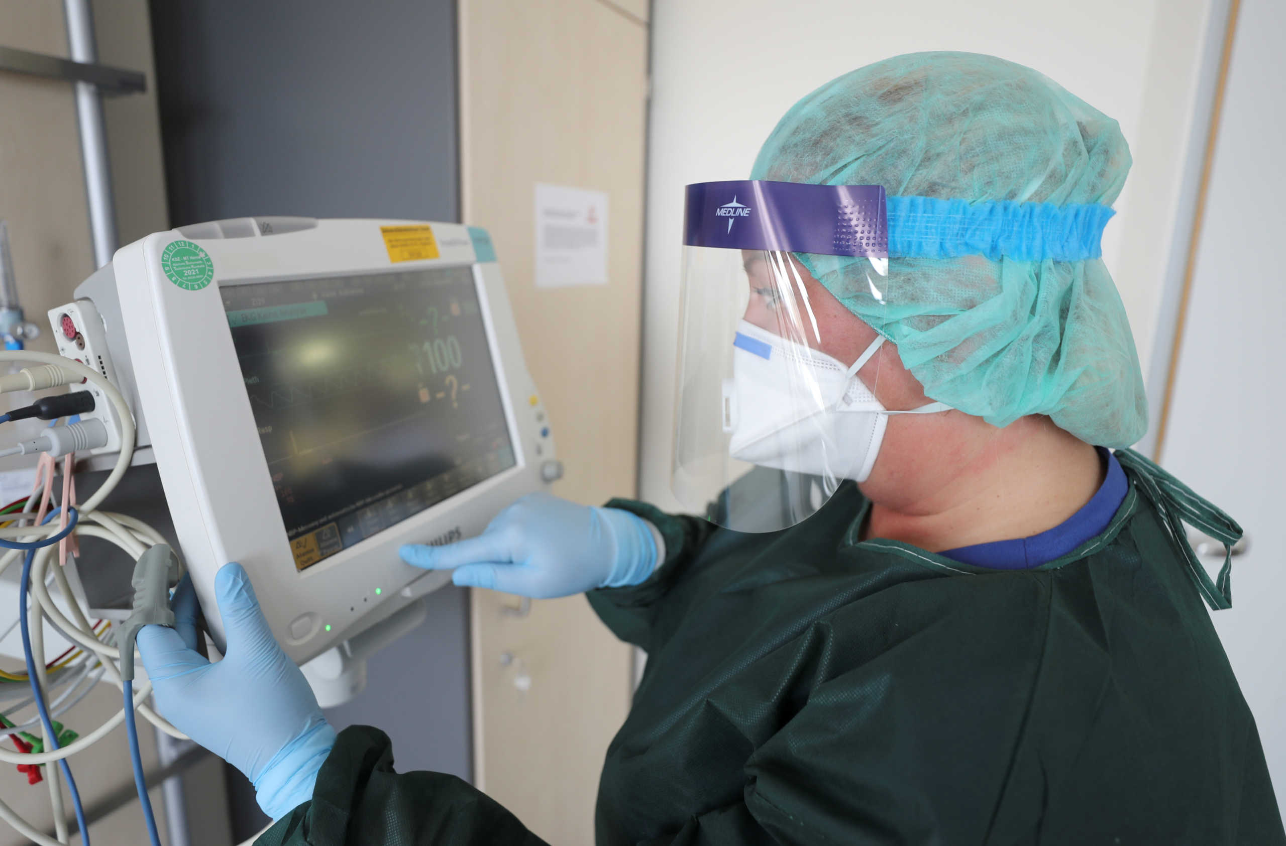 Canan Emcan, 31, chief nurse of the infection and virologist ward of the university clinic of Essen starts a control unit in a ready-to-use special sick room for possible coronavirus patients during a media event in Essen, Germany, March 5, 2020.   REUTERS