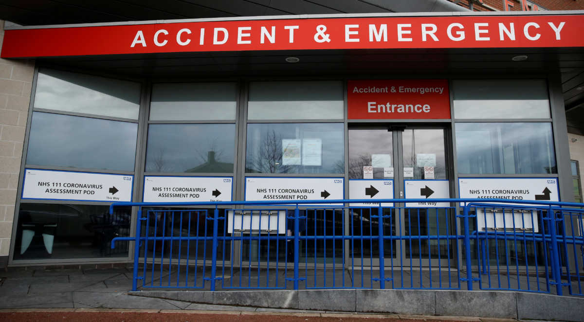 Signage directing patients towards a Coronavirus assessment bay is seen outside Whiston Hospital in Liverpool, Britain March 10, 2020. REUTERS