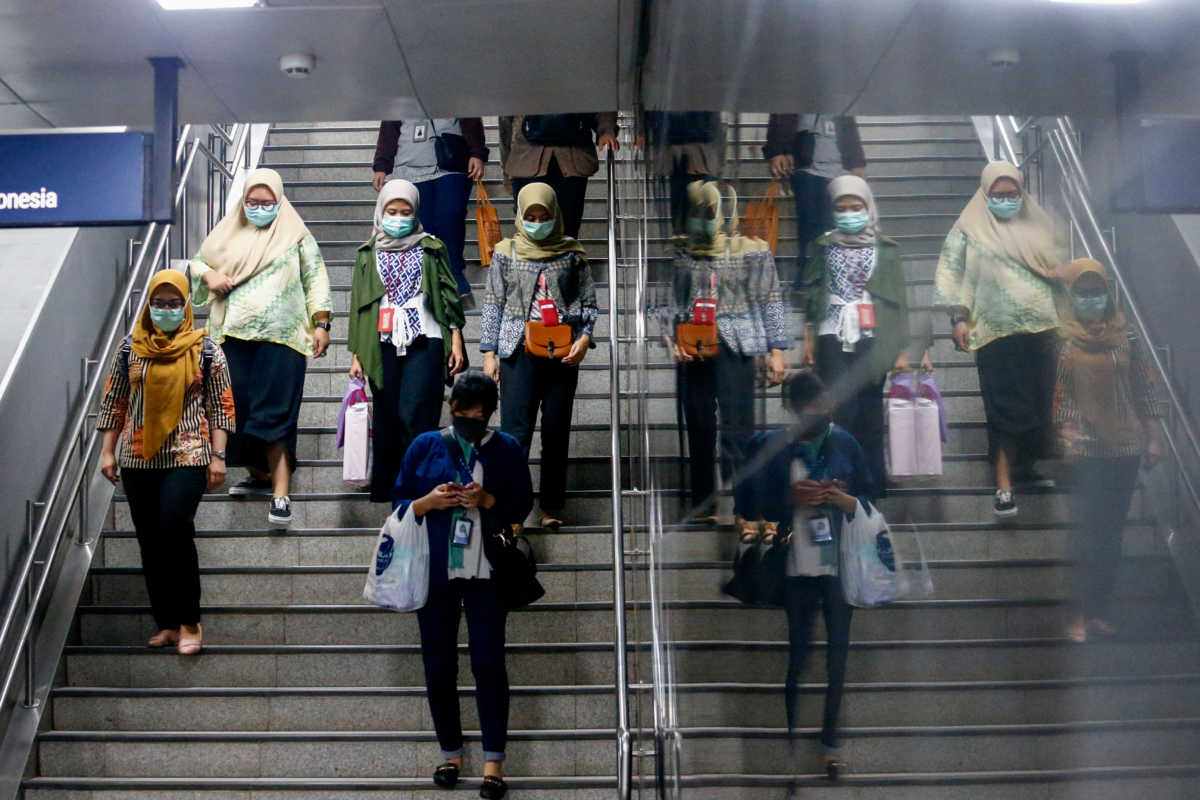 Women with protective masks walk on stairs, as Indonesia confirmed new cases of coronavirus disease (COVID-19), in Jakarta, Indonesia, March 11, 2020. REUTERS