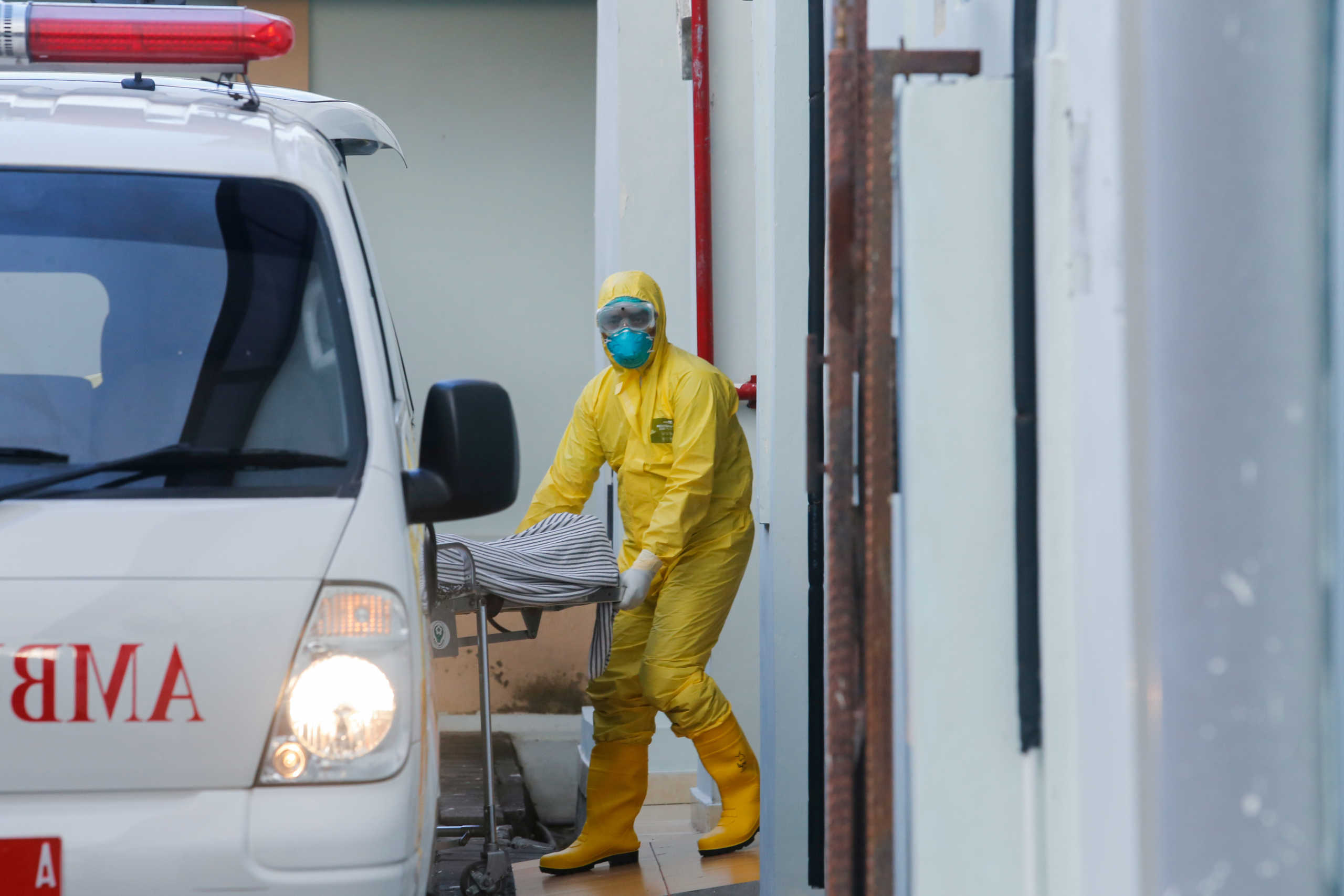 A medical worker wearing protective suits pulls a stretcher from an ambulance to the isolation room for patients affected coronavirus disease (COVID-19) at Sanglah Hospital in Denpasar, Bali, Indonesia, March 11, 2020. REUTERS