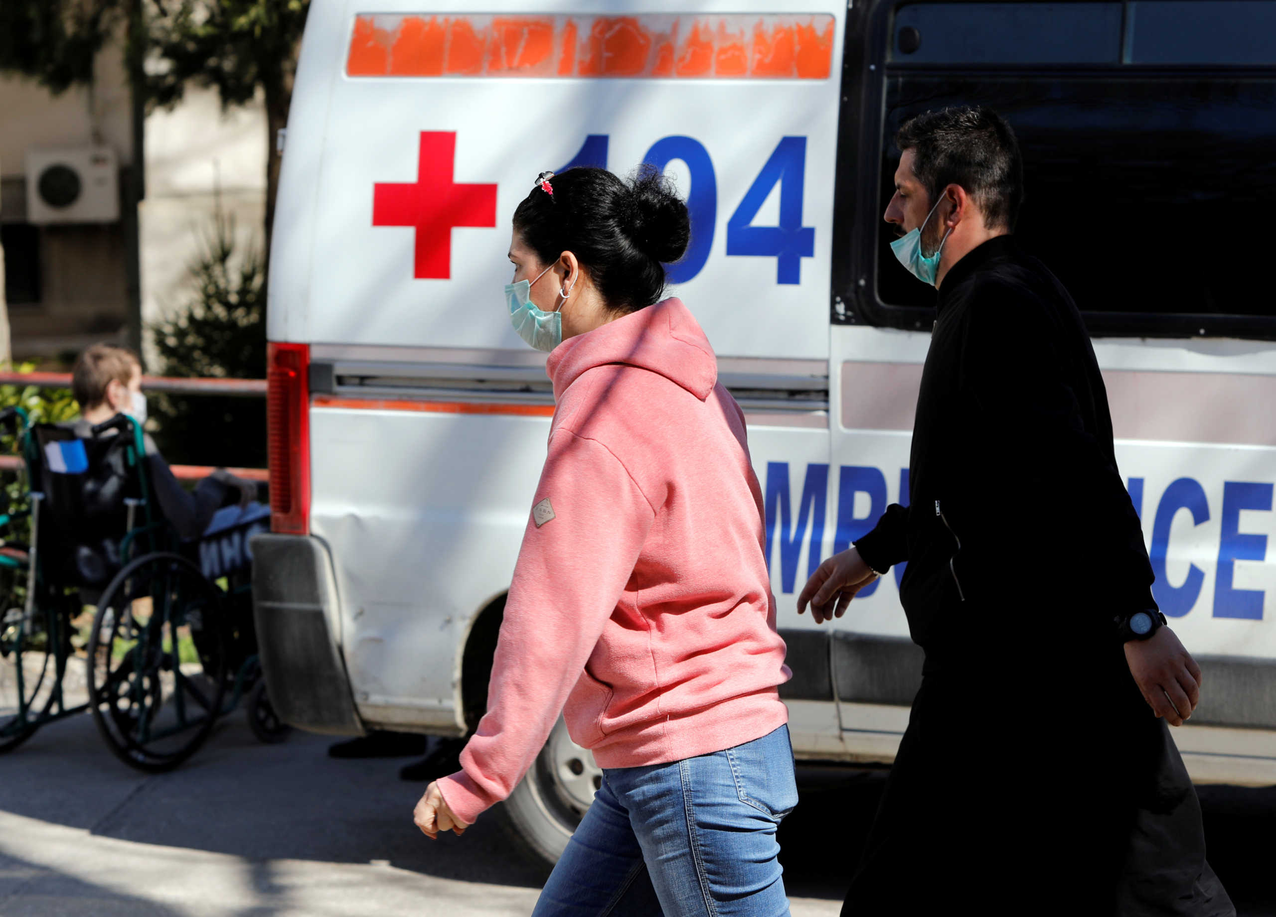 People and medical personnel walk with covered faces to protect against the coronavirus disease (COVID-19) at the state hospital in Skopje, North Macedonia March 12, 2020. REUTERS