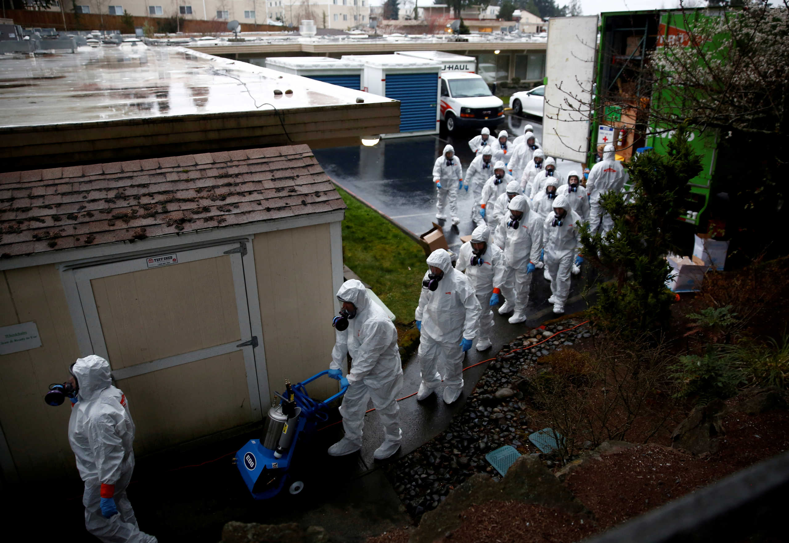 FILE PHOTO: Servpro workers file in to begin a third day of cleaning at the Life Care Center of Kirkland, a long-term care facility linked to several confirmed coronavirus cases, in Kirkland, Washington, U.S. March 13, 2020.  REUTERS