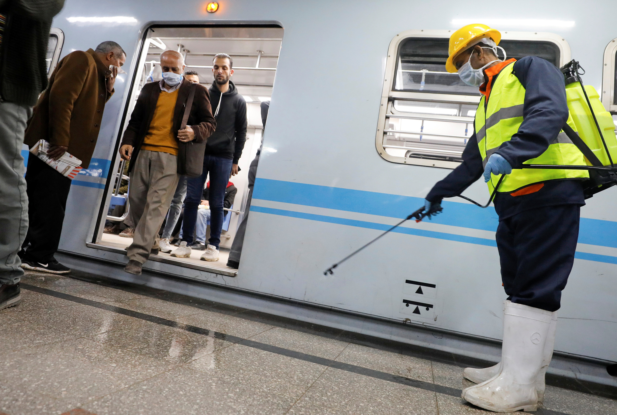 A member of medical team sprays disinfectant as a precautionary move amid concerns over the coronavirus disease (COVID-19) outbreak at the underground Al Shohadaa "Martyrs" metro station in Cairo, Egypt March 22, 2020. REUTERS