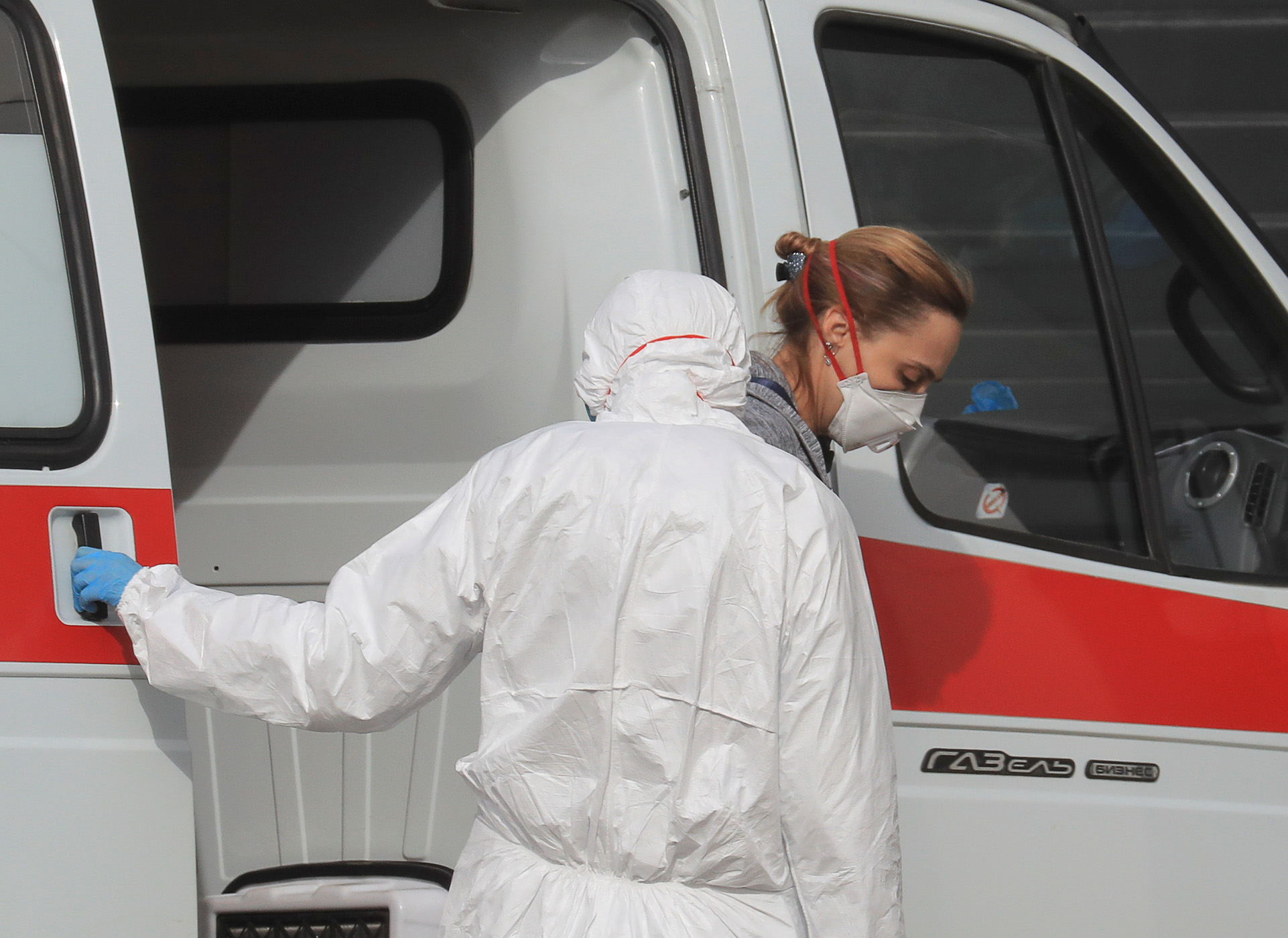 A woman wearing a protective mask gets out of an ambulance upon the arrival at a hospital for patients infected with coronavirus disease (COVID-19) on the outskirts of Moscow, Russia March 19, 2020. REUTERS