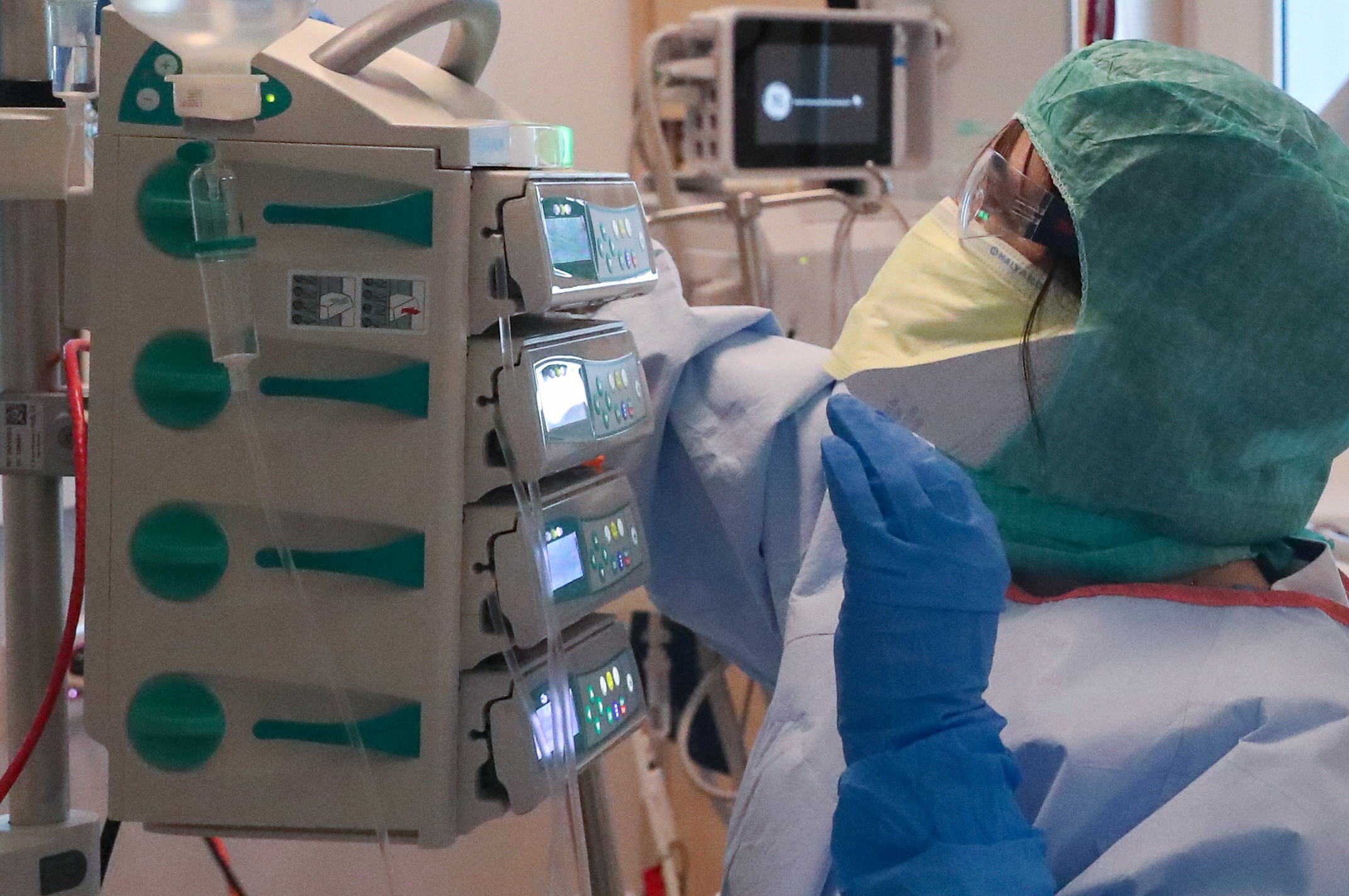 A member of the medical personnel works as a patient suffering from coronavirus disease (COVID-19) is treated at the intensive care unit at MontLegia CHC clinic in Liege, Belgium, March 26, 2020.  REUTERS