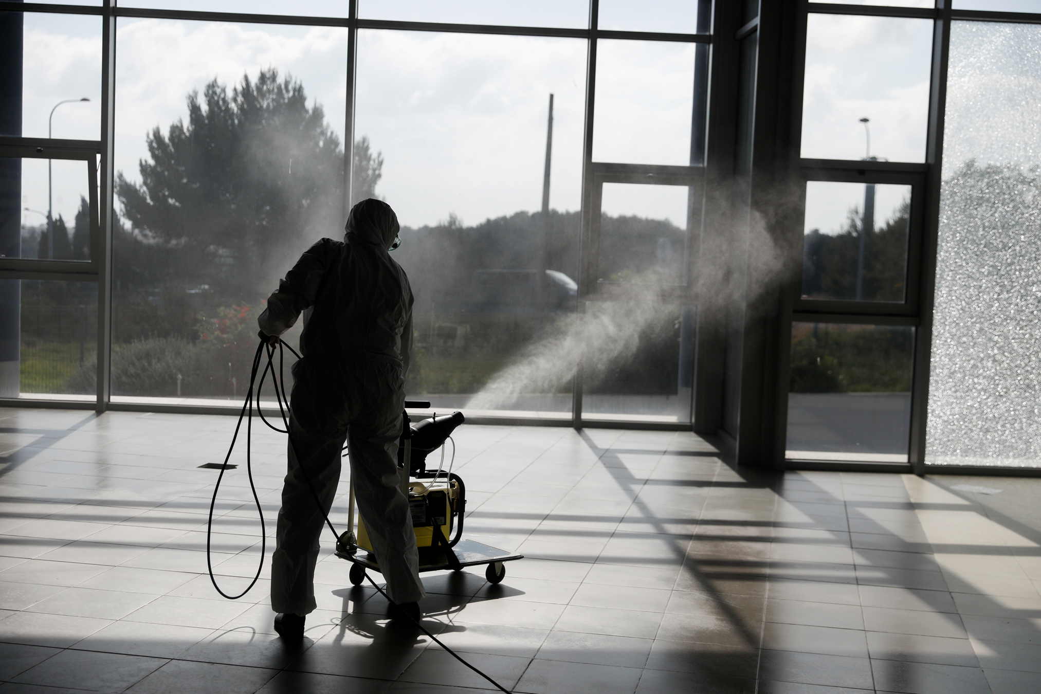 A municipal worker disinfect a warehouse with hospital material, to stop the spread of coronavirus disease (COVID-19) in Cascais, Portugal March 27, 2020. REUTERS