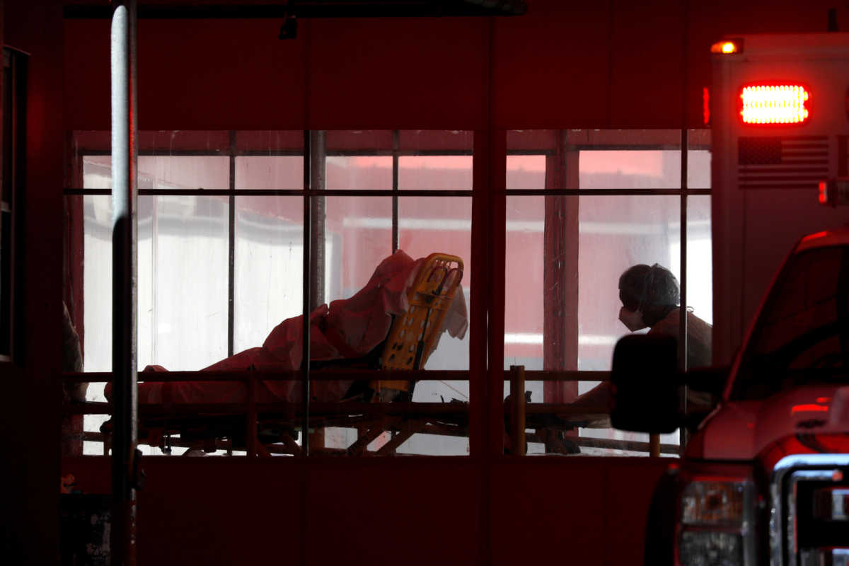 A patient is wheeled into the trauma center at the Elmhurst Hospital Center where testing and treatment for the coronavirus disease (COVID-19) is taking place in Queens, New York City, U.S., March 27, 2020. REUTERS