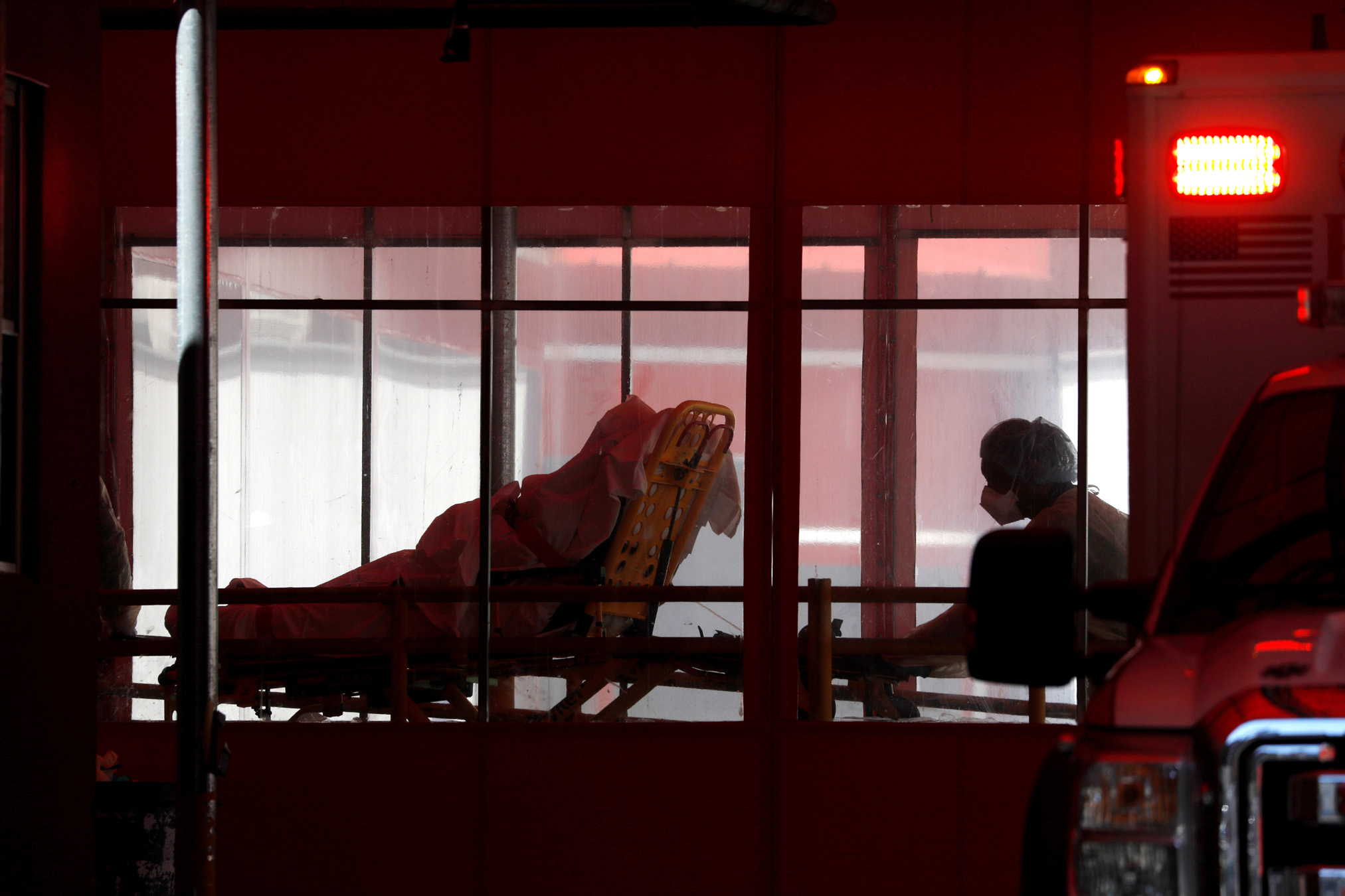 A patient is wheeled into the trauma center at the Elmhurst Hospital Center where testing and treatment for the coronavirus disease (COVID-19) is taking place in Queens, New York City, U.S., March 27, 2020. REUTERS