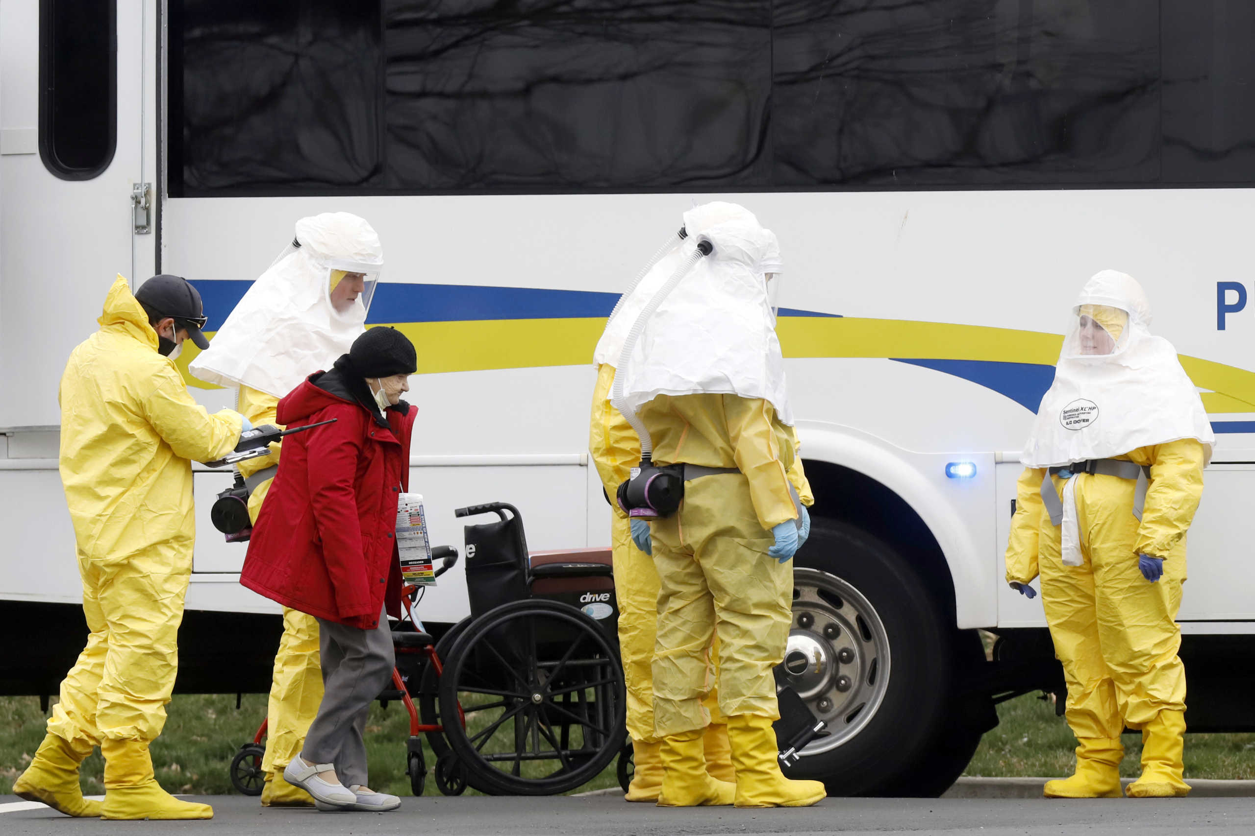 Medical officials aid a residents from St. Joseph's nursing home to board a bus, after a number of residents tested positive for coronavirus disease (COVID-19) in Woodbridge, New Jersey, U.S., March 25, 2020.  REUTERS