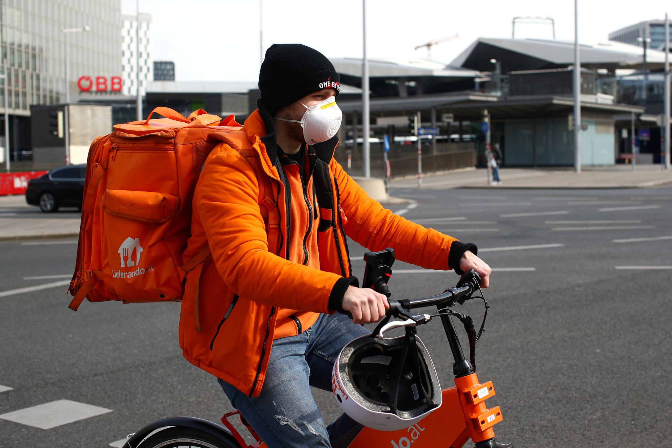 A food delivery worker wears a protective mask, during the coronavirus disease (COVID-10) outbreak, in Vienna, Austria March 26, 2020. REUTERS