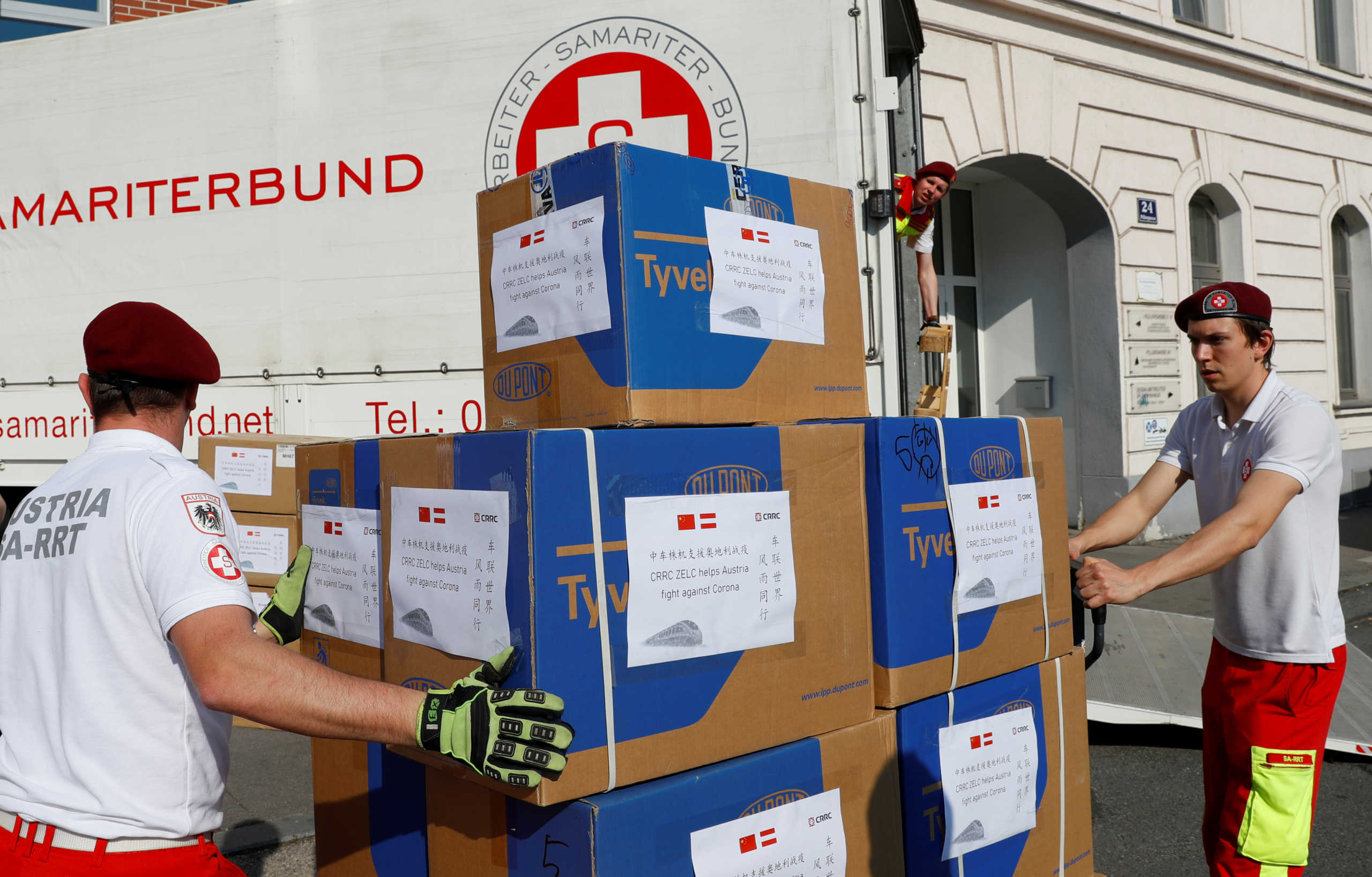 Members of the Austrian Samaritan Team (Samariter Bund) move boxes with protective gear as they load a truck during the spread of coronavirus disease (COVID-19) in Vienna, Austria March 20, 2020.   REUTERS