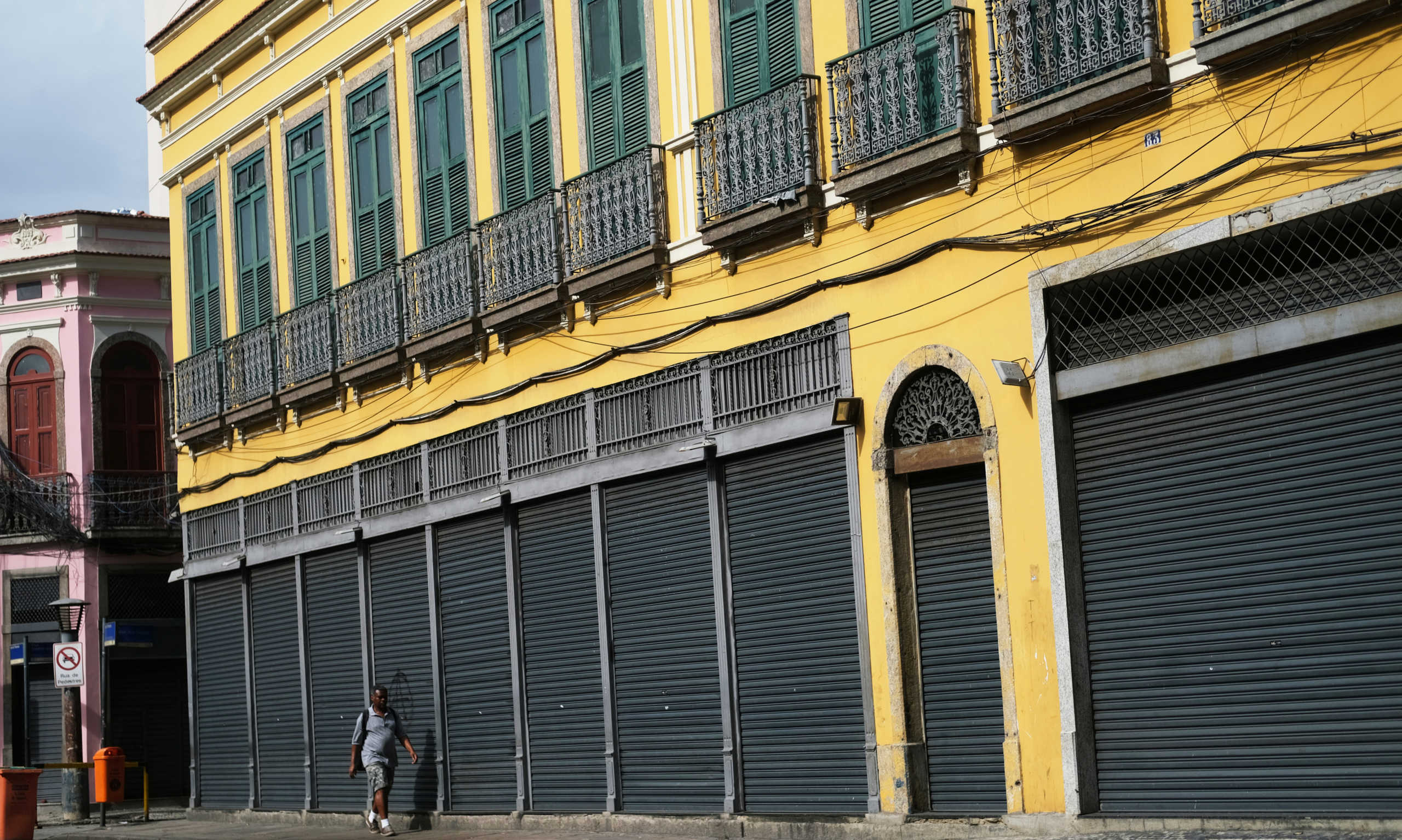 A man walks next to closed stores in Rio de Janeiros' downtown during the coronavirus disease (COVID-19) outbreak, Brazil, March 24, 2020. REUTERS