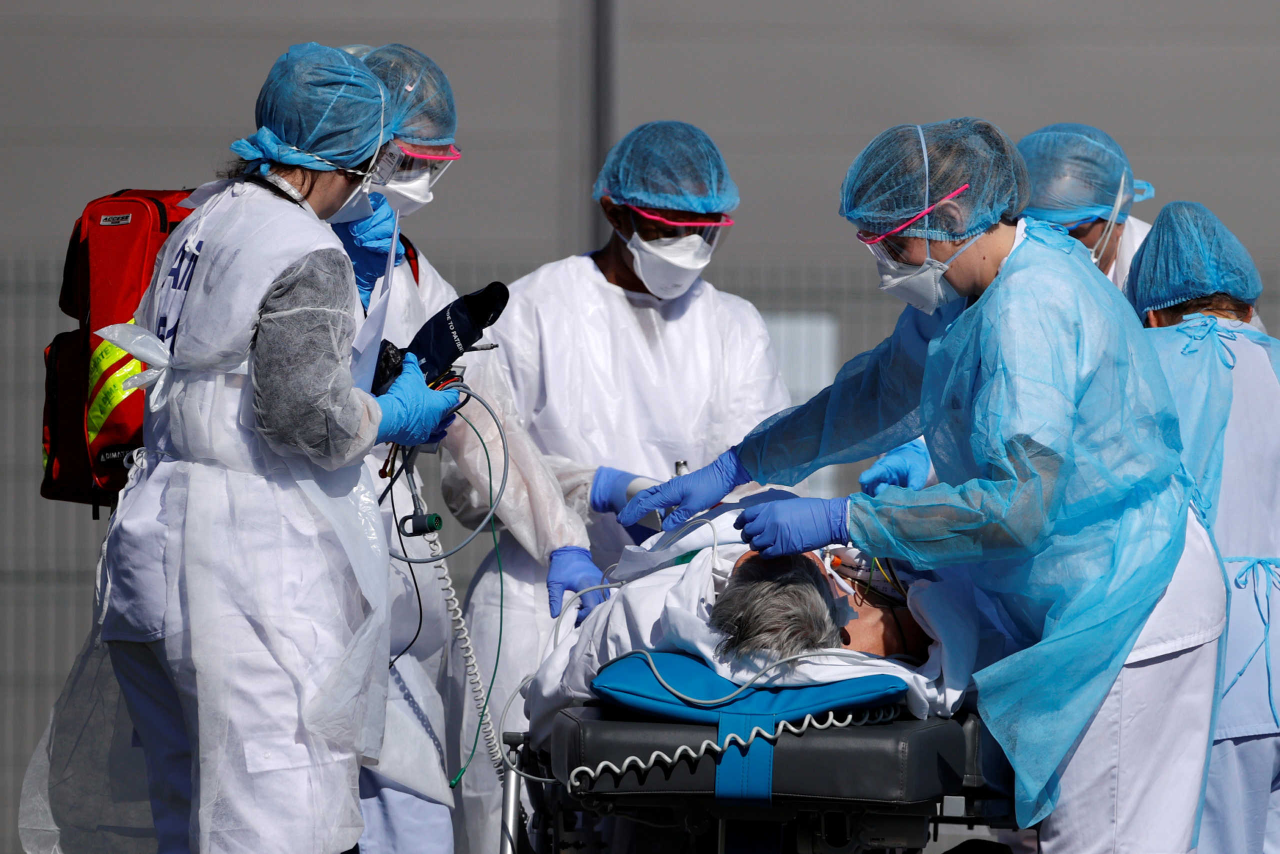 French rescue team wearing protective suits carry a patient on a stretcher from Mulhouse hospital before being loaded into a helicopter as France faces an aggressive progression of the coronavirus disease (COVID-19), March 23, 2020. REUTERS