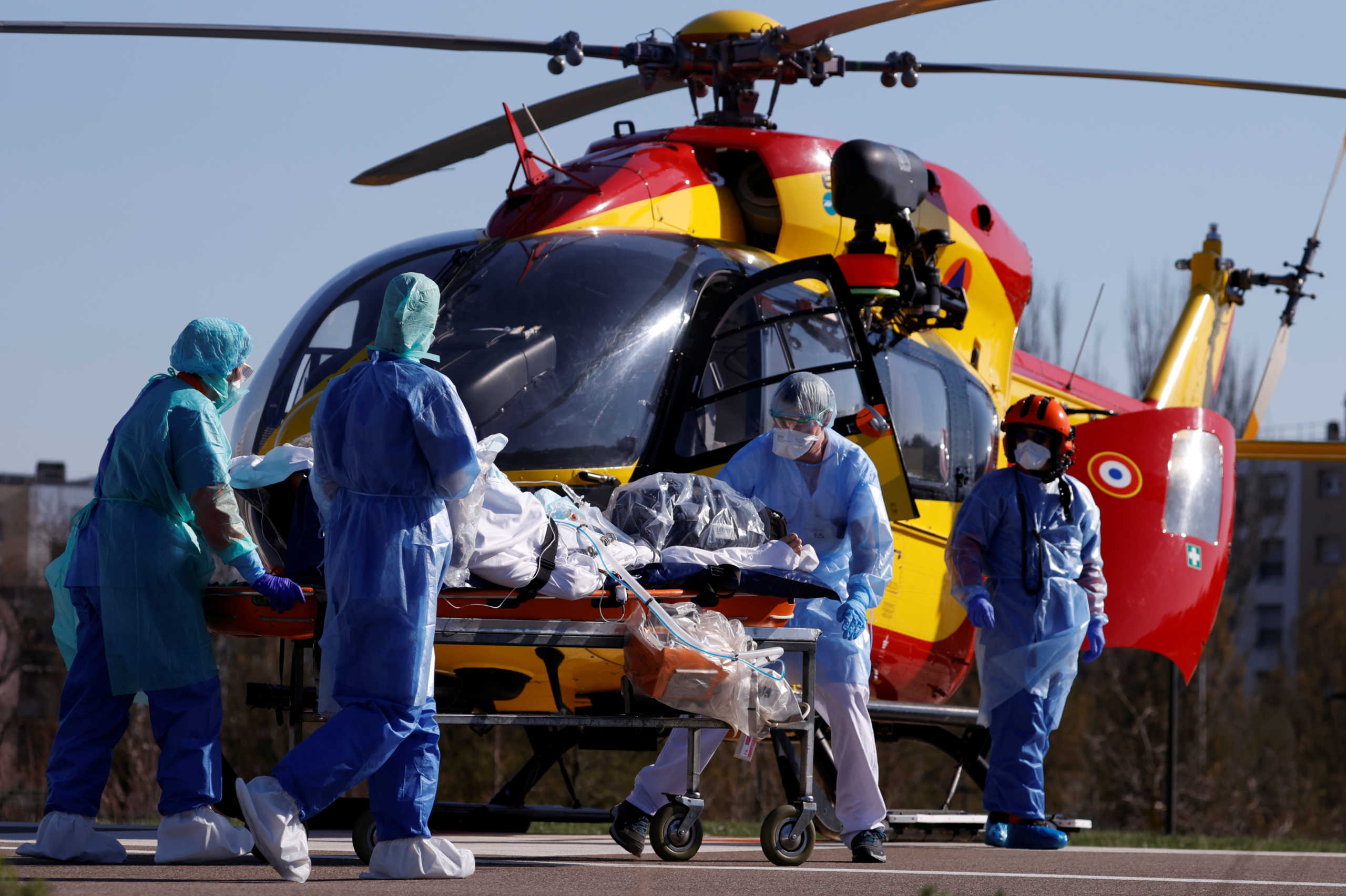 A patient infected with coronavirus is carried on a stretcher by a French rescue team before being transferred by a helicopter of the civil security (Securite Civile) from Strasbourg university hospital to Pforzheim in Germany as the spread of the coronavirus disease (COVID-19) continues, in France, March 24, 2020. REUTERS