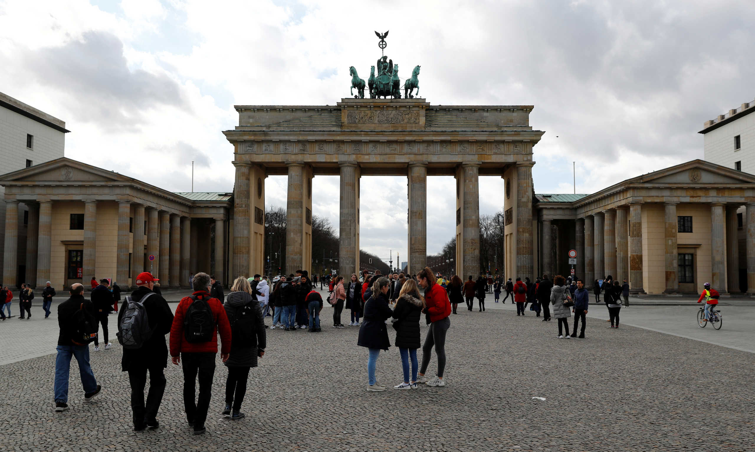 People are pictured in front of the Brandenburg Gate as Berlin authorities took new measures to cancel events with over 1,000 people because of the coronavirus disease (COVID-19) in Berlin, Germany, March 11, 2020.    REUTERS