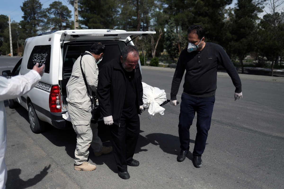 Iranian men carry the coffin of the journalist Abdollah Zavieh, who passed away due to coronavirus disease (COVID-19), to bury him at Behesht Zahra cemetery in Tehran, Iran, March 24, 2020. WANA (West Asia News Agency)