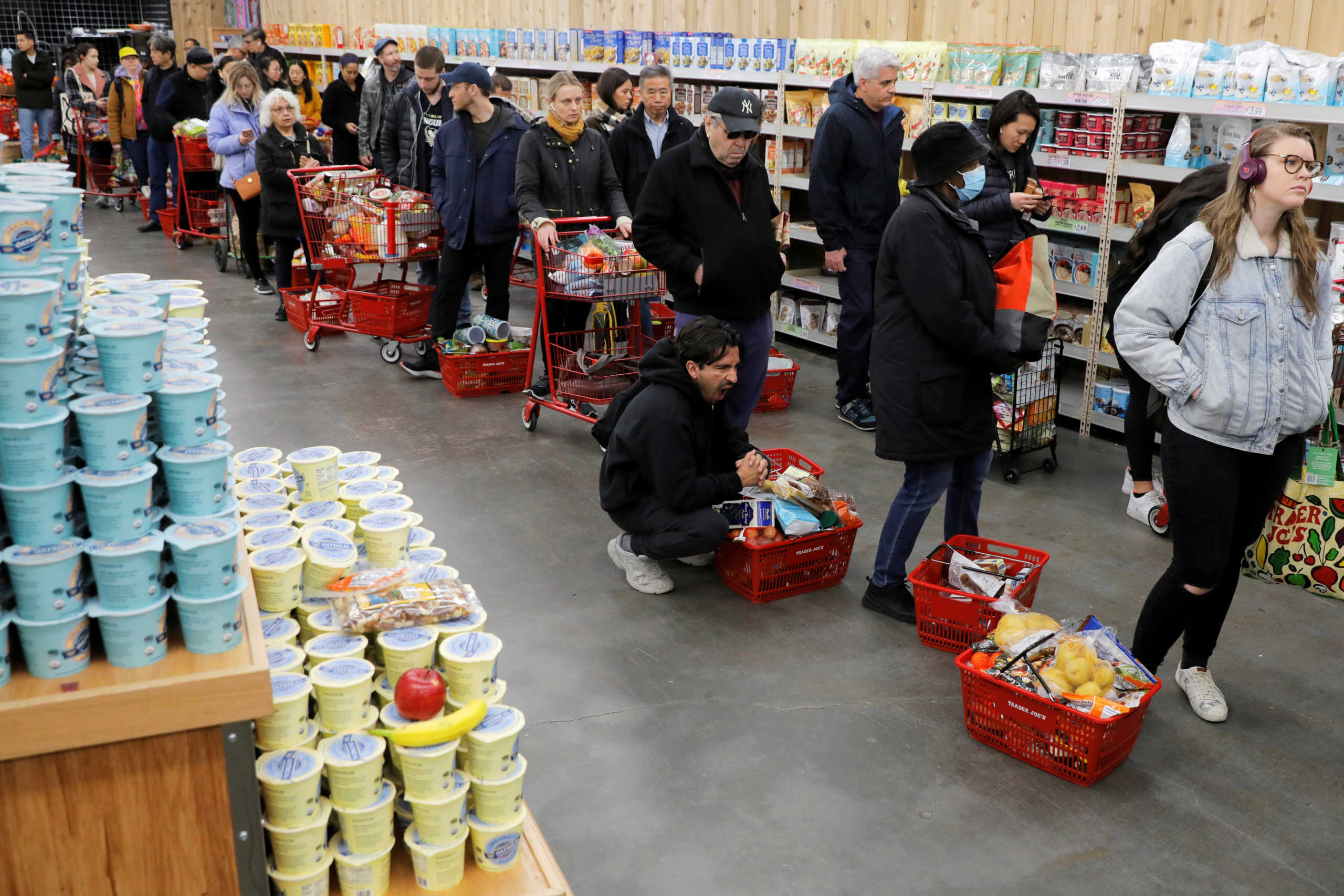 People line up to purchase goods at a downtown Trader Joe's as more cases of coronavirus were confirmed in Manhattan, New York City, New York, U.S., March 12, 2020. REUTERS