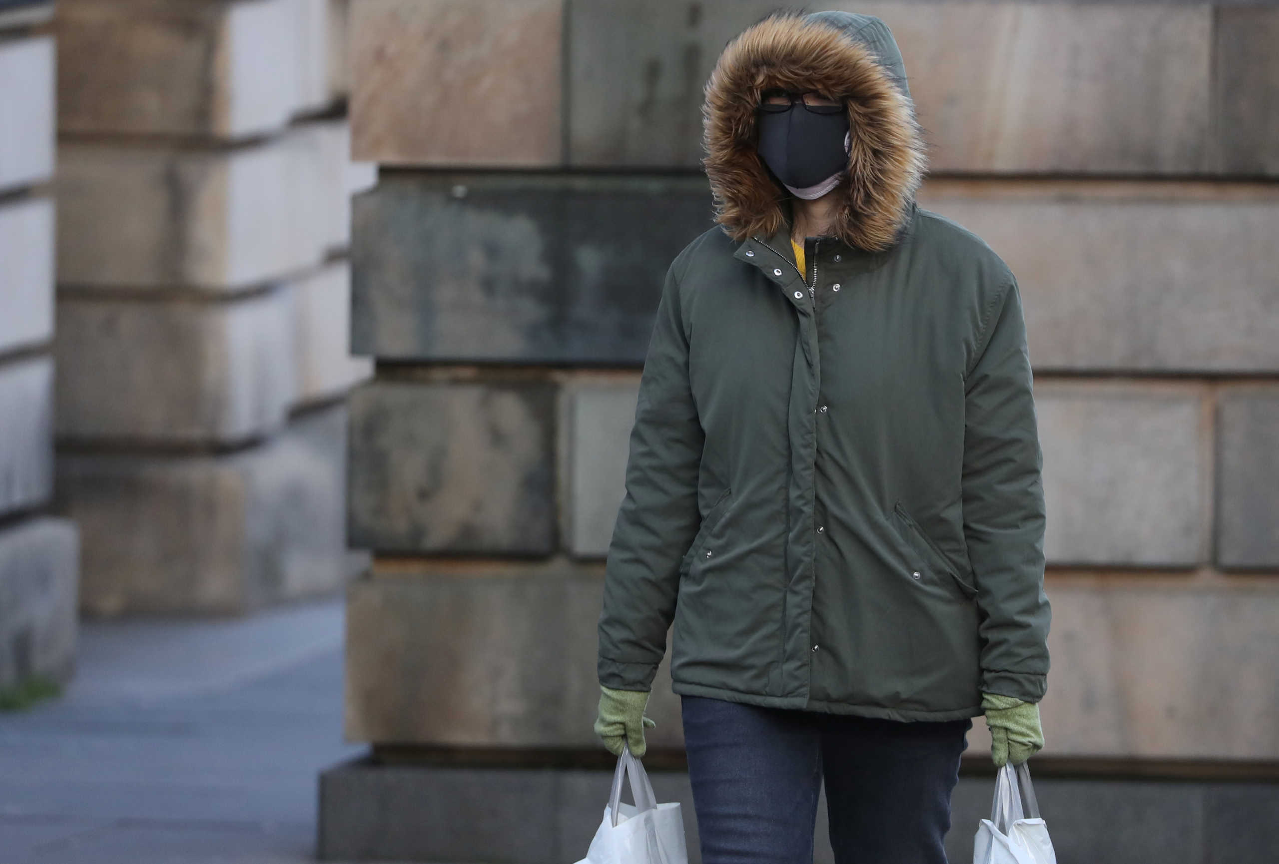 A person wearing a mask walks in the Royal Mile in Edinburgh, Scotland, Britain March 2, 2020. REUTERS