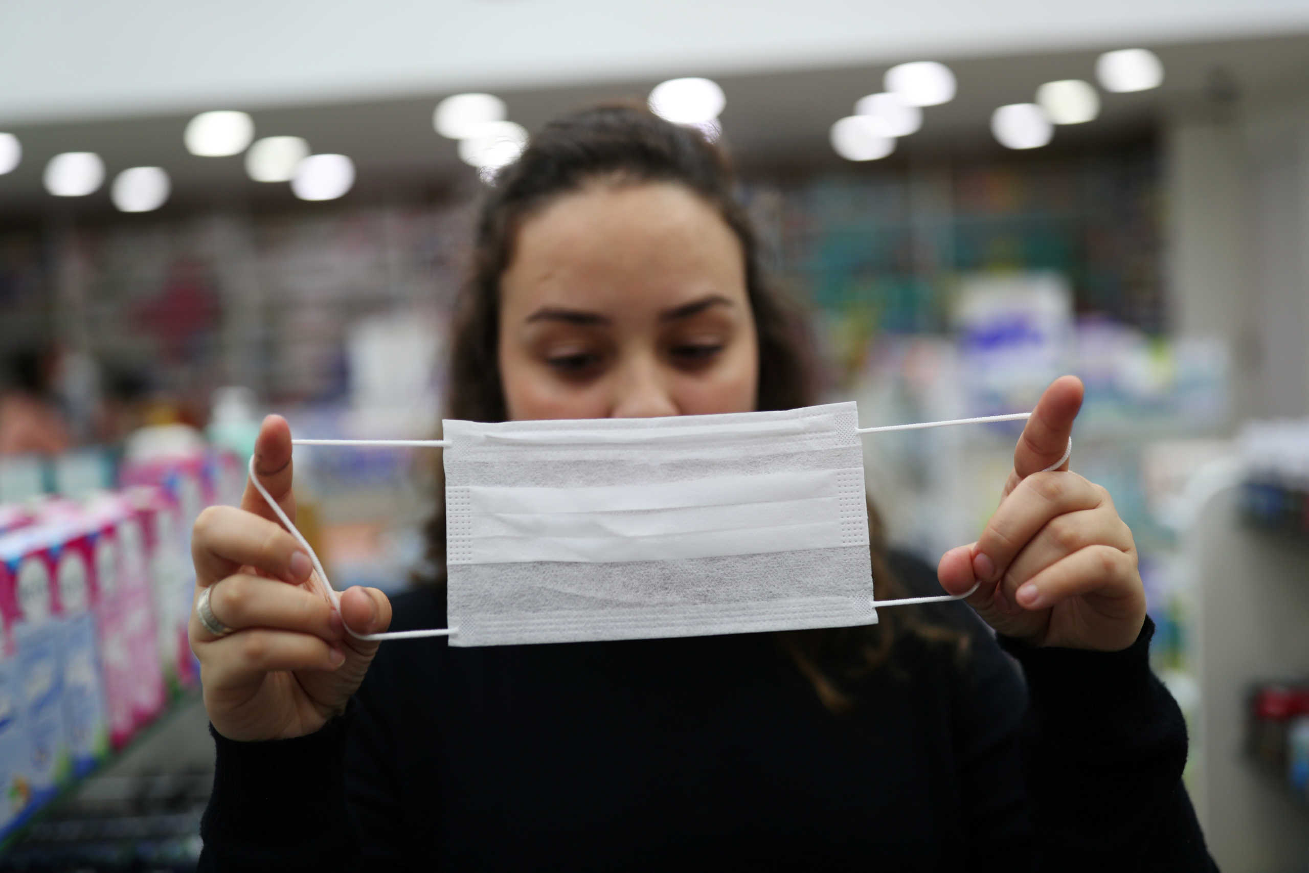A vendor displays a protective mask at a pharmacy, after the second case of coronavirus in Sao Paulo was confirmed, at Guarulhos International Airport in Guarulhos, Sao Paulo state, Brazil, February 29, 2020. REUTERS