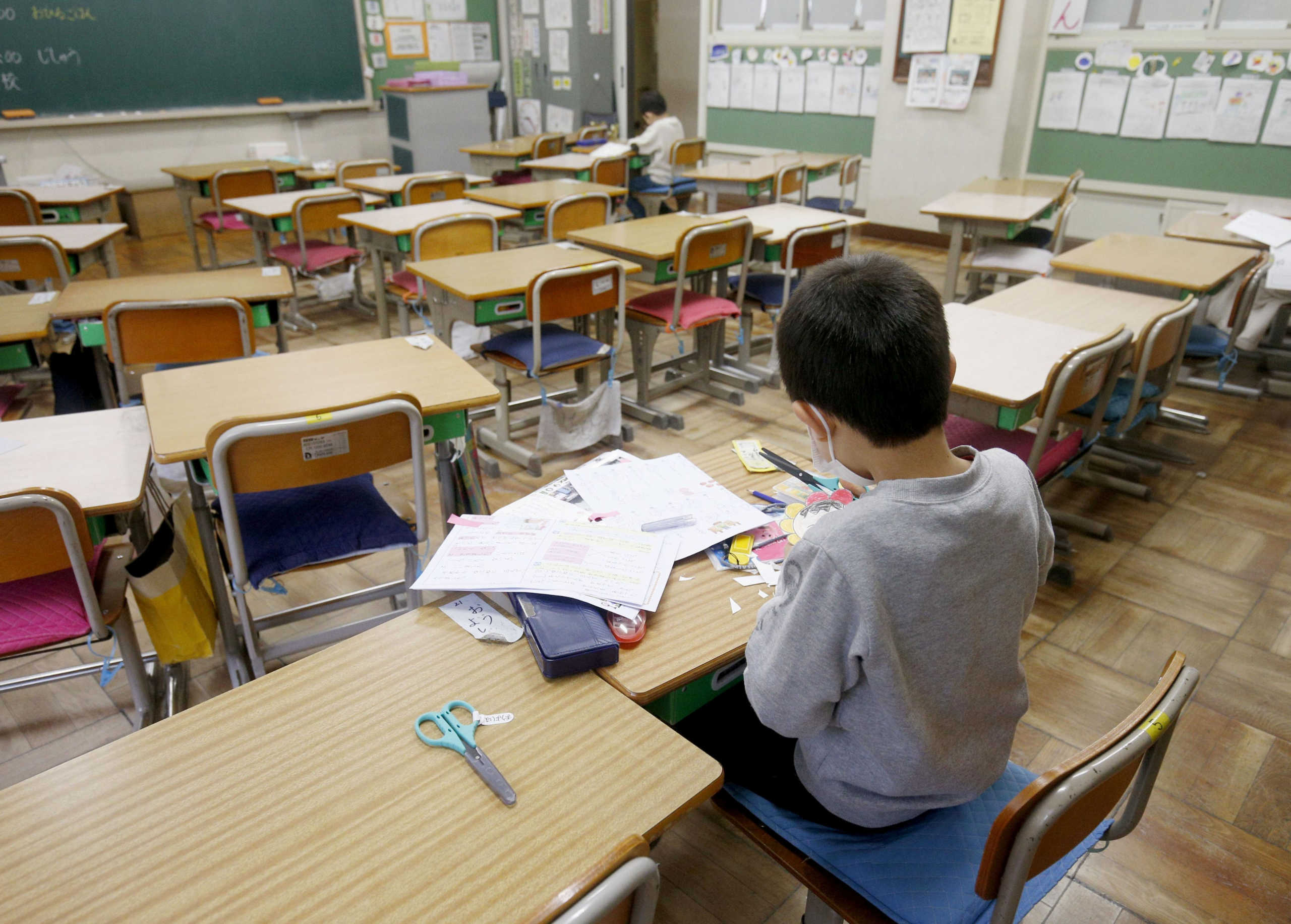 Two students do self-study at an elementary school where the facility was opened for children who cannot stay at home alone while their parents are at work, in Saitama, Japan March 2, 2020, in this photo taken by Kyodo.  Mandatory credit Kyodo