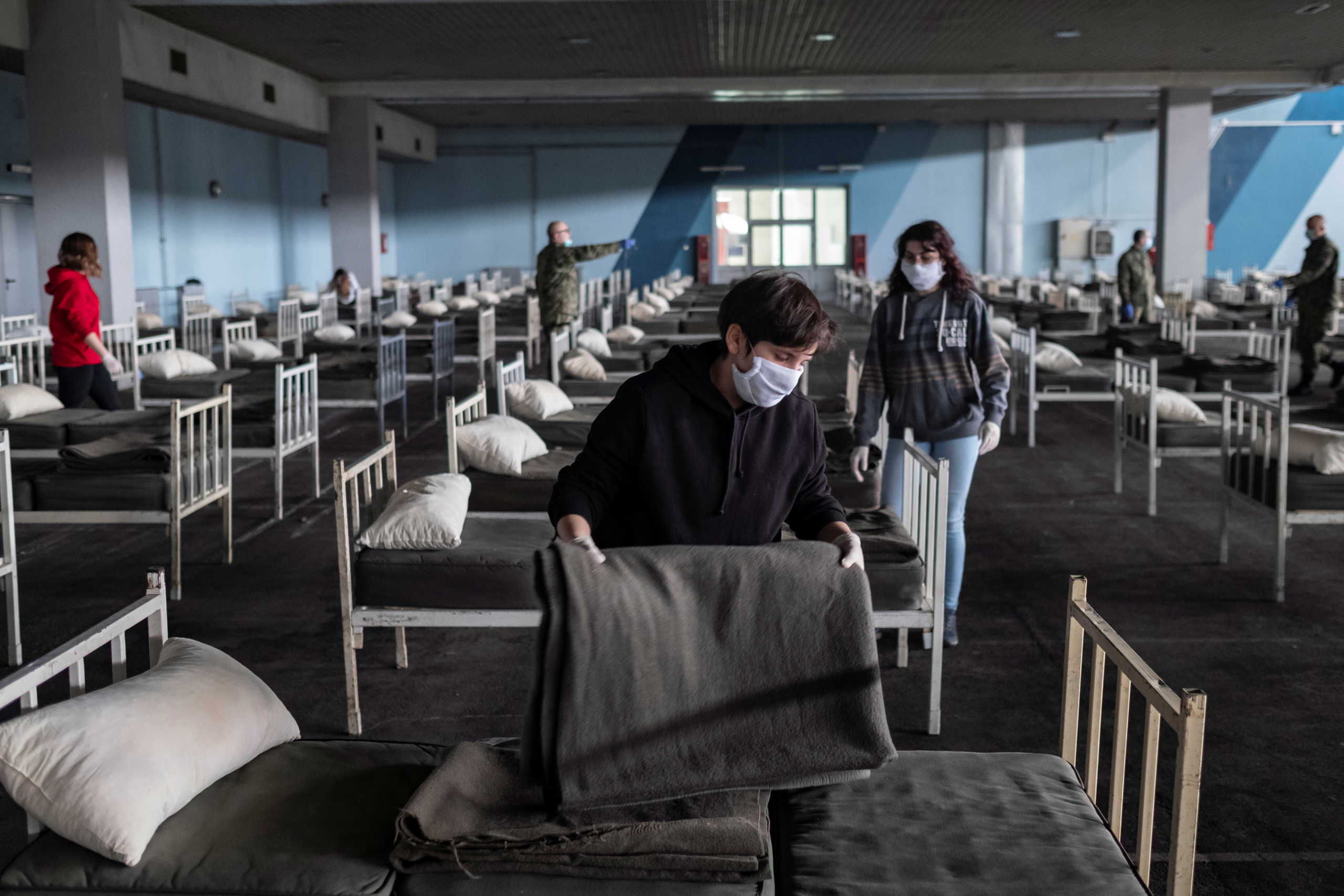 Serbian military and volunteers set up beds inside the Novi Sad Fair to accommodate people who suffer mild symptoms of coronavirus disease (COVID-19) in Novi Sad, Serbia, March 27, 2020. REUTERS