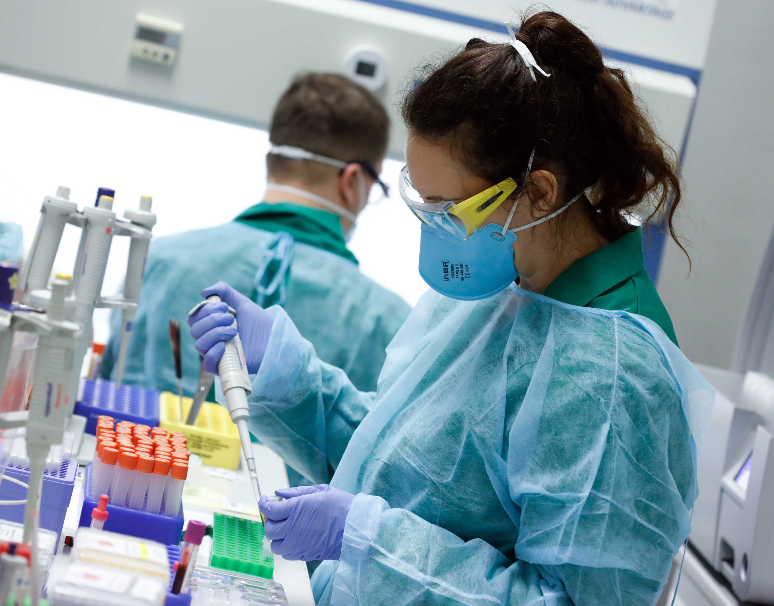 Employees in protective clothing do testings for the corona virus at a laboratory in Berlin, Germany, March 26, 2020, as the spread of the coronavirus disease (COVID-19) continues. REUTERS