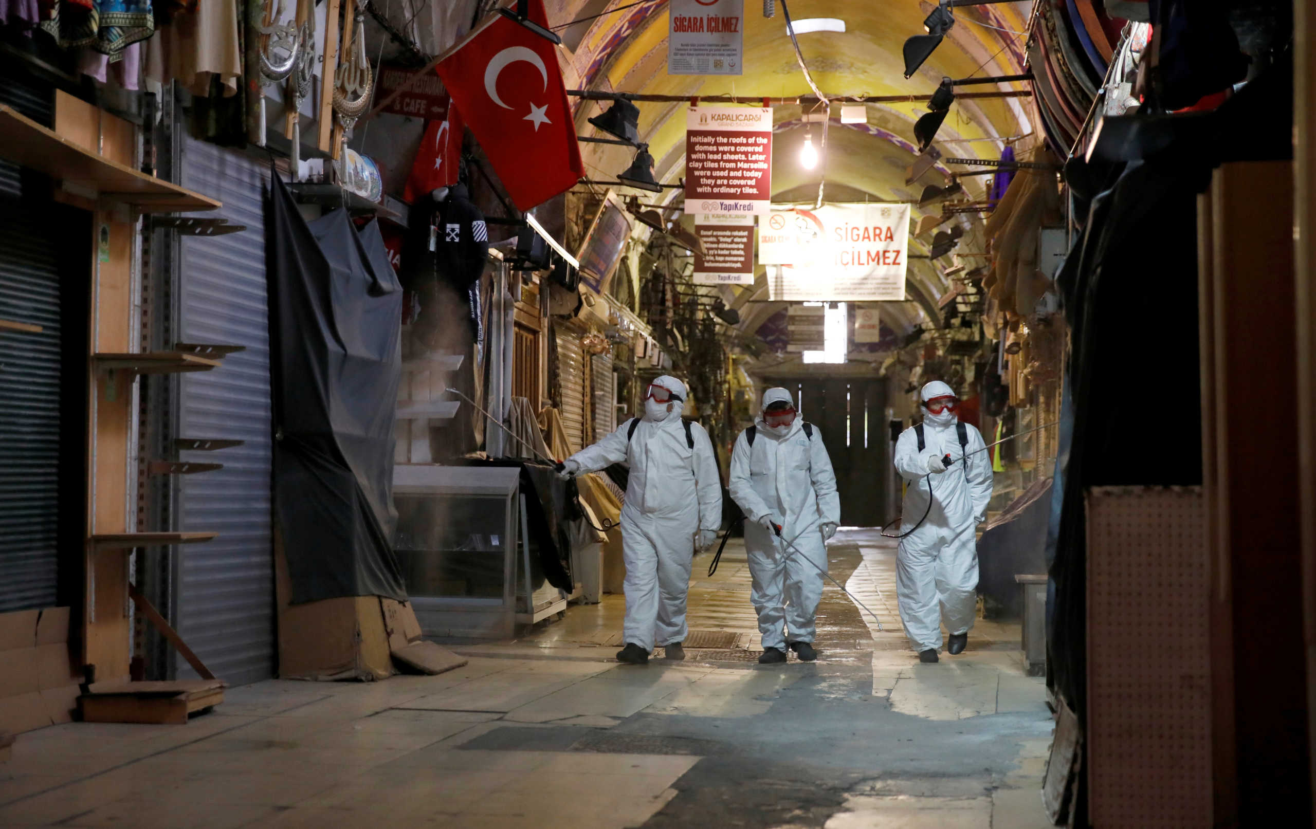FILE PHOTO: Workers in protective suits spray disinfectant at Grand Bazaar, known as the Covered Bazaar, to prevent the spread of coronavirus disease (COVID-19), in Istanbul, Turkey, March 25, 2020. REUTERS