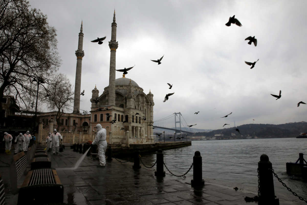 A worker sprays disinfectant outside Ortakoy Mosque, to prevent the spread of coronavirus disease (COVID-19), in Istanbul, Turkey, March 23, 2020. REUTERS