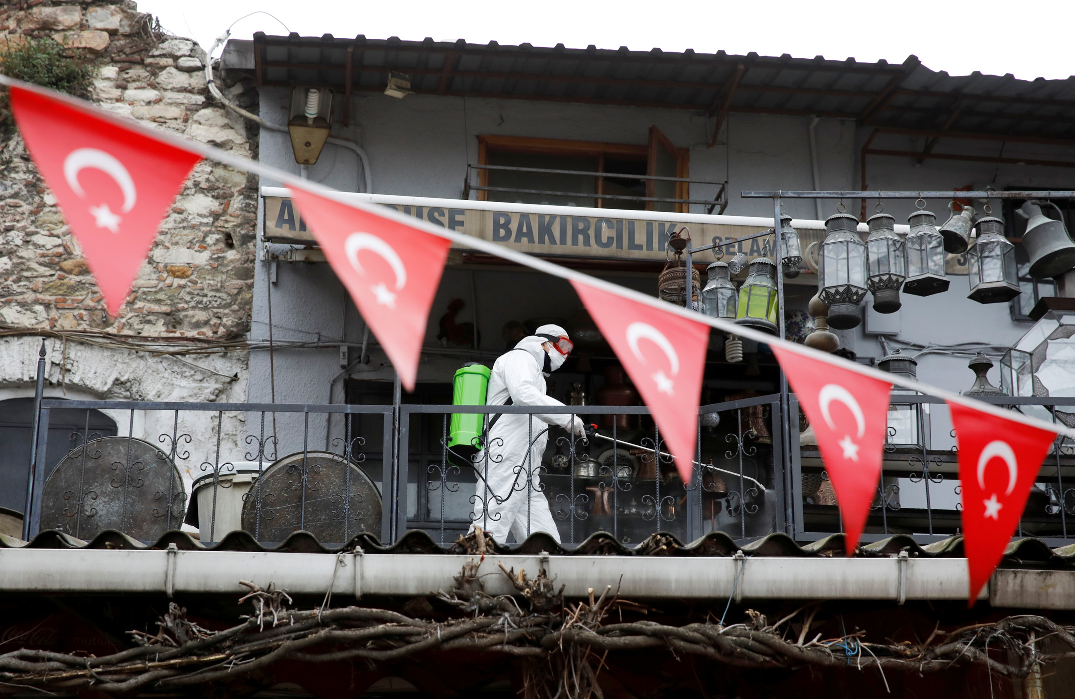 A worker in a protective suit sprays disinfectant at Grand Bazaar, known as the Covered Bazaar, to prevent the spread of coronavirus disease (COVID-19), in Istanbul, Turkey, March 25, 2020. REUTERS