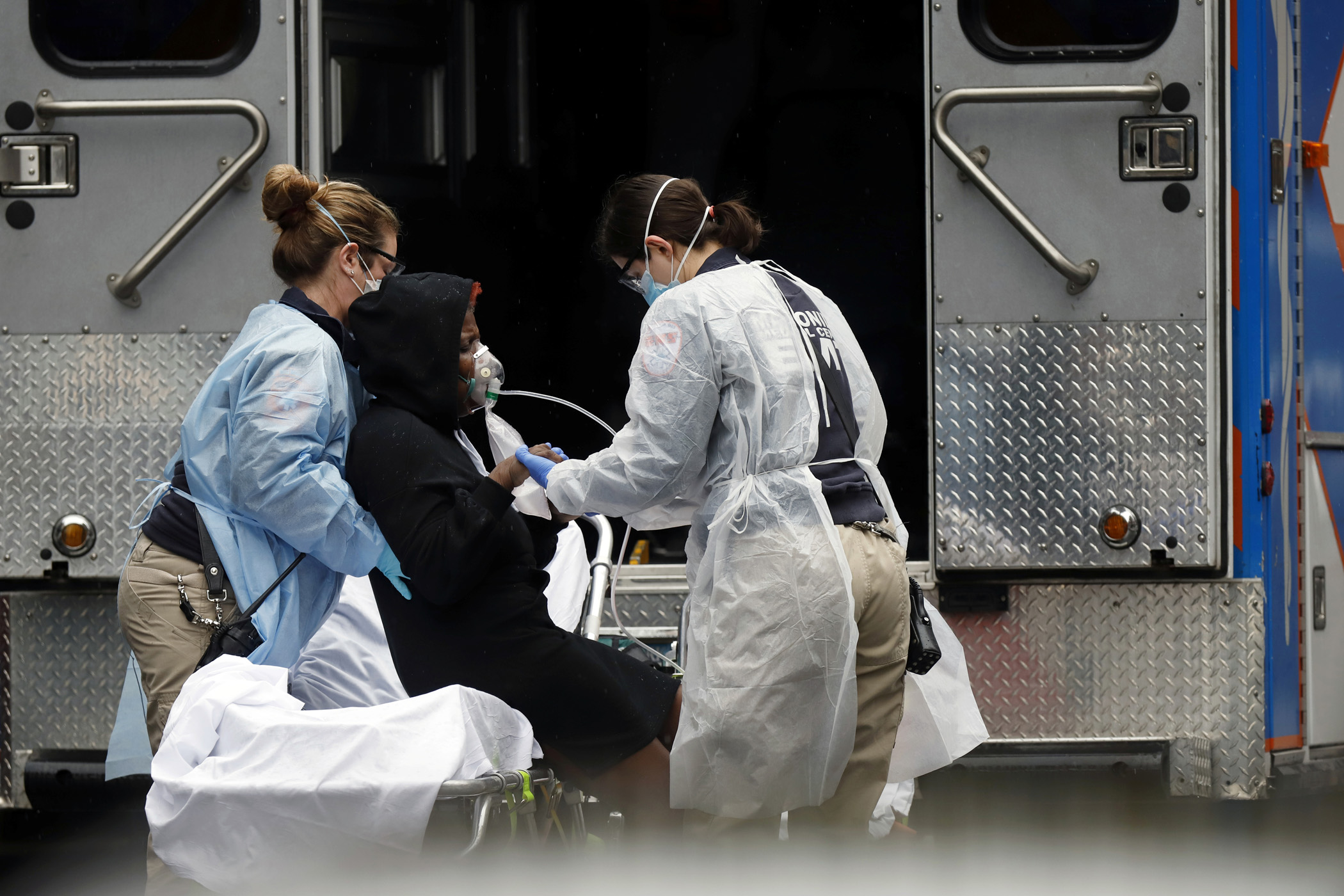 Emergency Medical Technicians (EMT) wearing protective gears wheel a sick patient to a waiting ambulance during the outbreak of coronavirus disease (COVID-19) in New York City, New York, U.S., March 28, 2020.  REUTERS